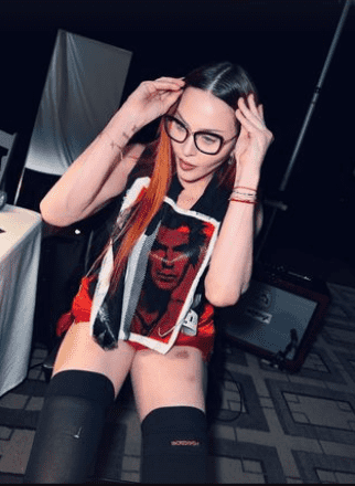 Madonna completed her look with an angular set of black-framed glasses, and she had a chunky white belt strapped around her torso (madonna/Instagram)
