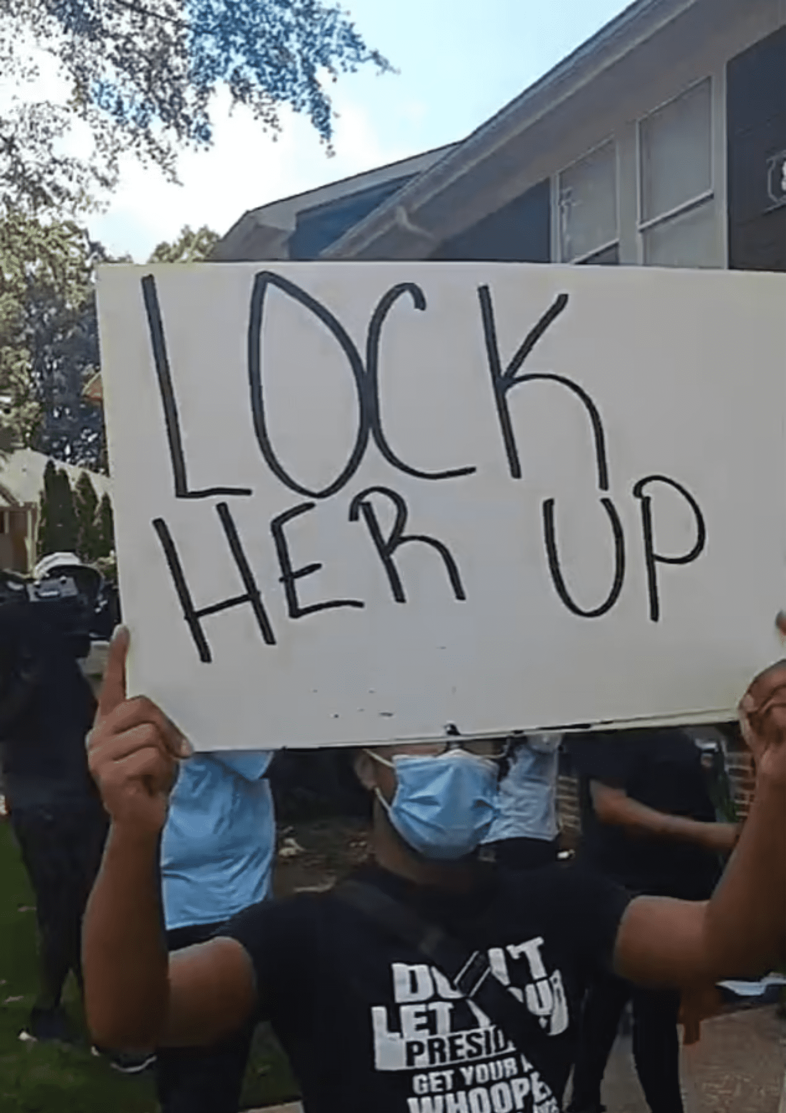 Activists were seen holding up signs that read 'Lock her up' outside the senior home where they thought Carolyn Bryant Donham lived  (Malik Z Shabazz/Facebook)