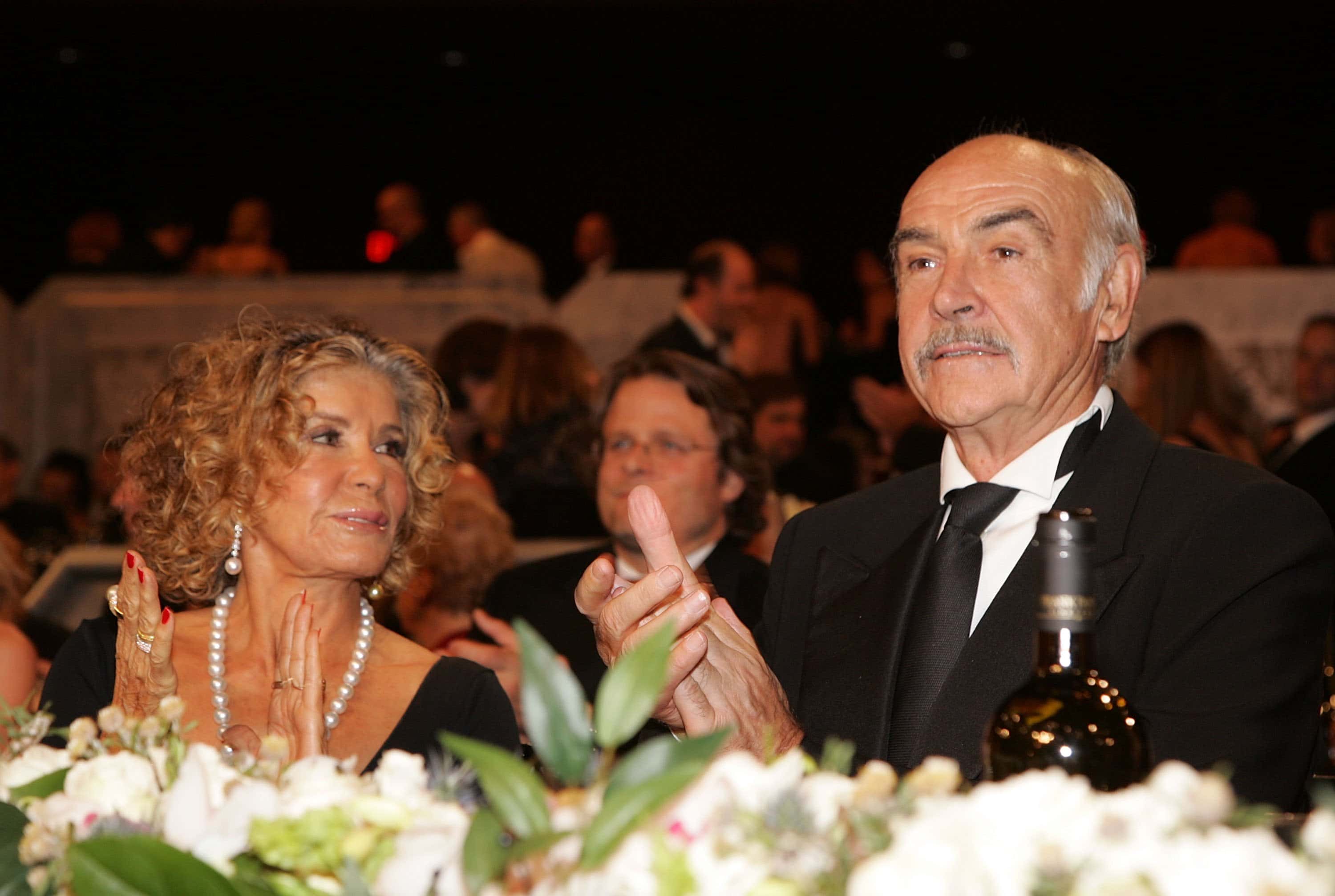 Actor Sean Connery (R) and wife Micheline Roquebrune (L) watch the show during the 34th AFI Life Achievement Award tribute to Sir Sean Connery held at the Kodak Theatre on June 8, 2006 in Hollywood, California.