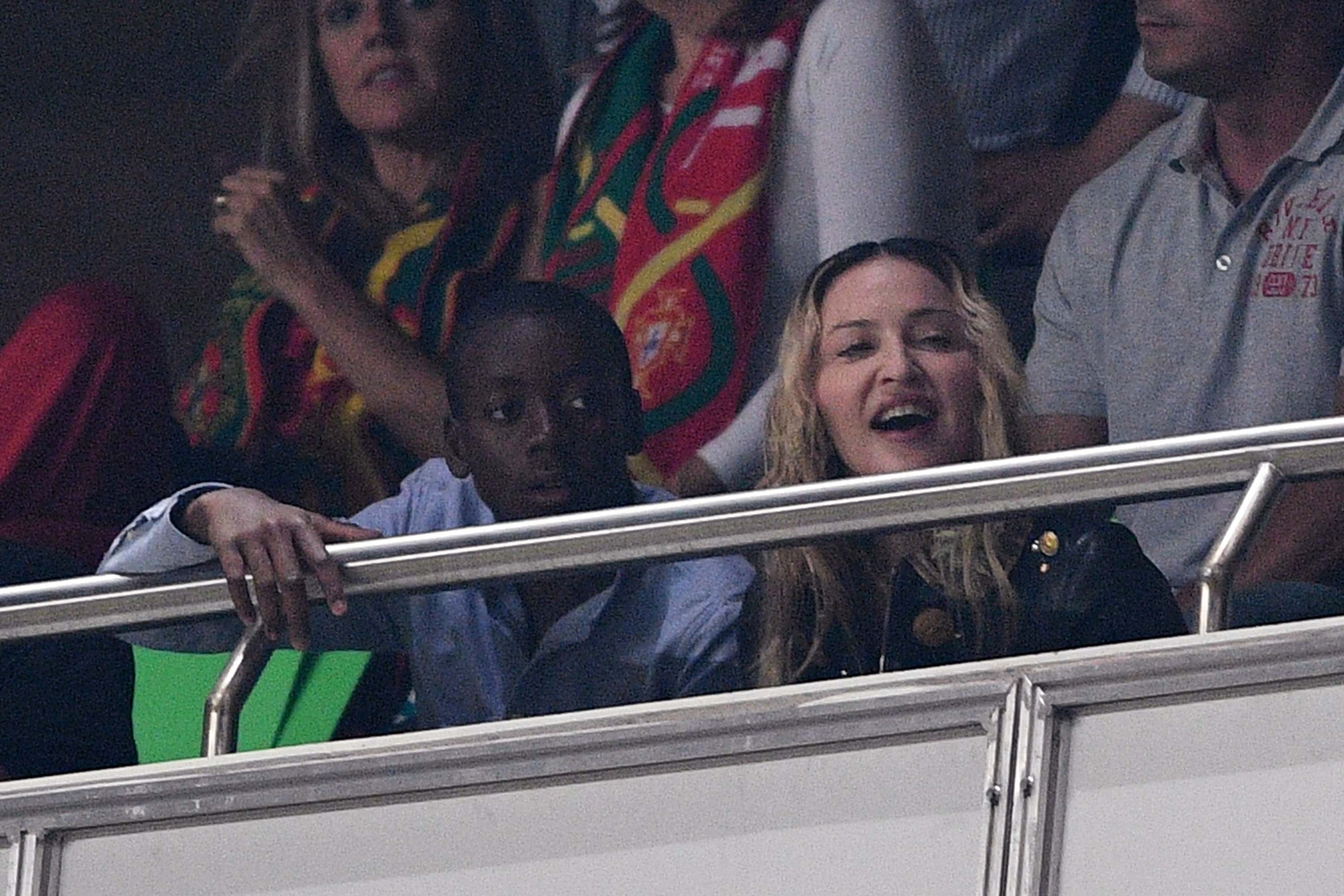 Madonna and son David Banda (L) watch the FIFA 2018 World Cup Qualifier between Portugal and Switzerland at the Luz Stadium on October 10, 2017 in Lisbon, Lisboa.
