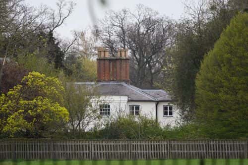A general view of the exterior of Frogmore Cottage as people lay floral tributes to Prince Philip, Duke Of Edinburgh who died at age 99, nearby on April 10, 2021 in Windsor, United Kingdom. The Queen announced the death of her beloved husband, His Royal Highness Prince Philip, Duke of Edinburgh. HRH passed away peacefully April 9th at Windsor Castle.
