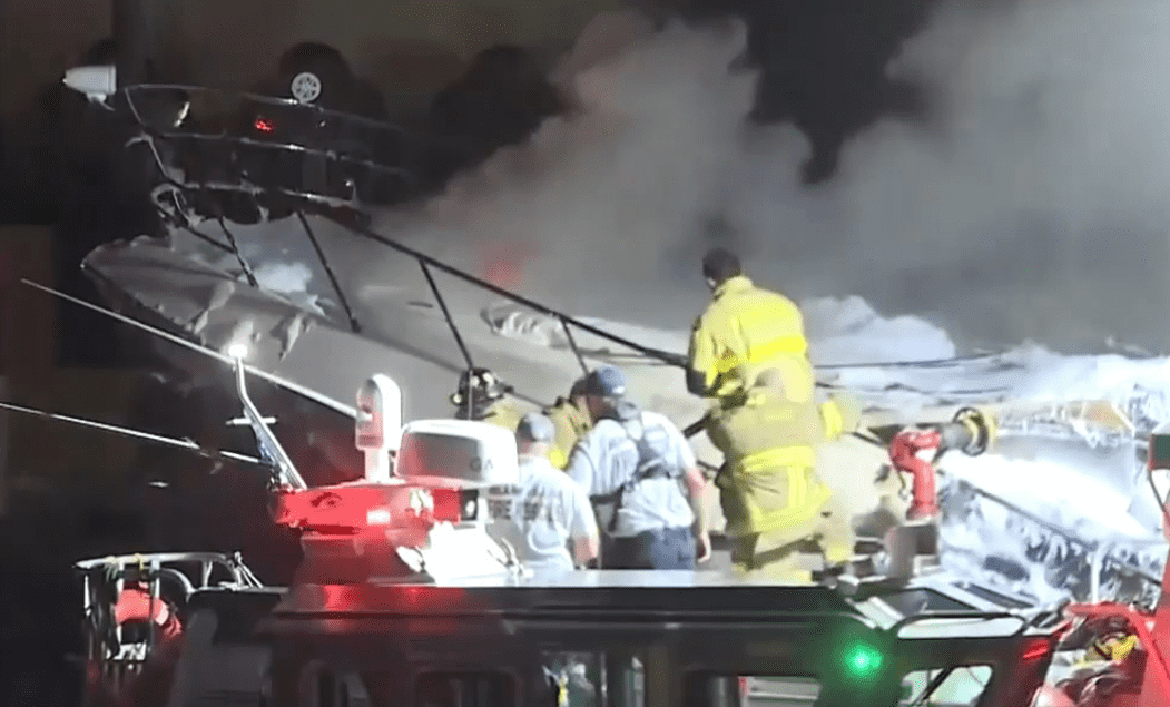 Rescue team trying to put down the fire on a 75-foot yacht (WSVN)