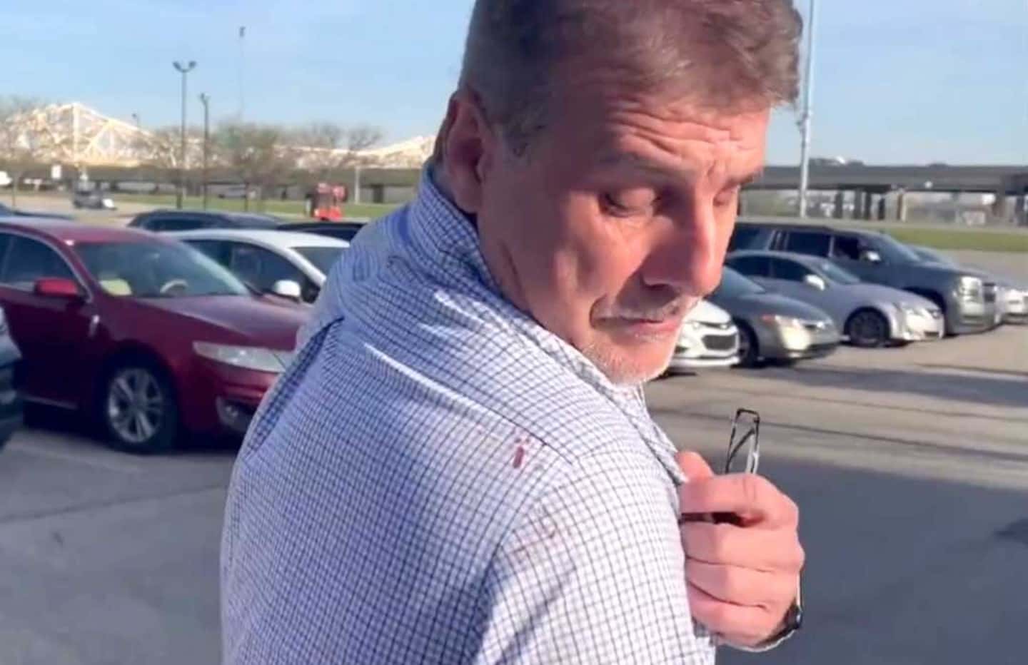 Troy Haste who survived the bank shooting shows the dried blood on his shirt saying it was the blood of someone who sat next to him in the conference room (WLKY)
