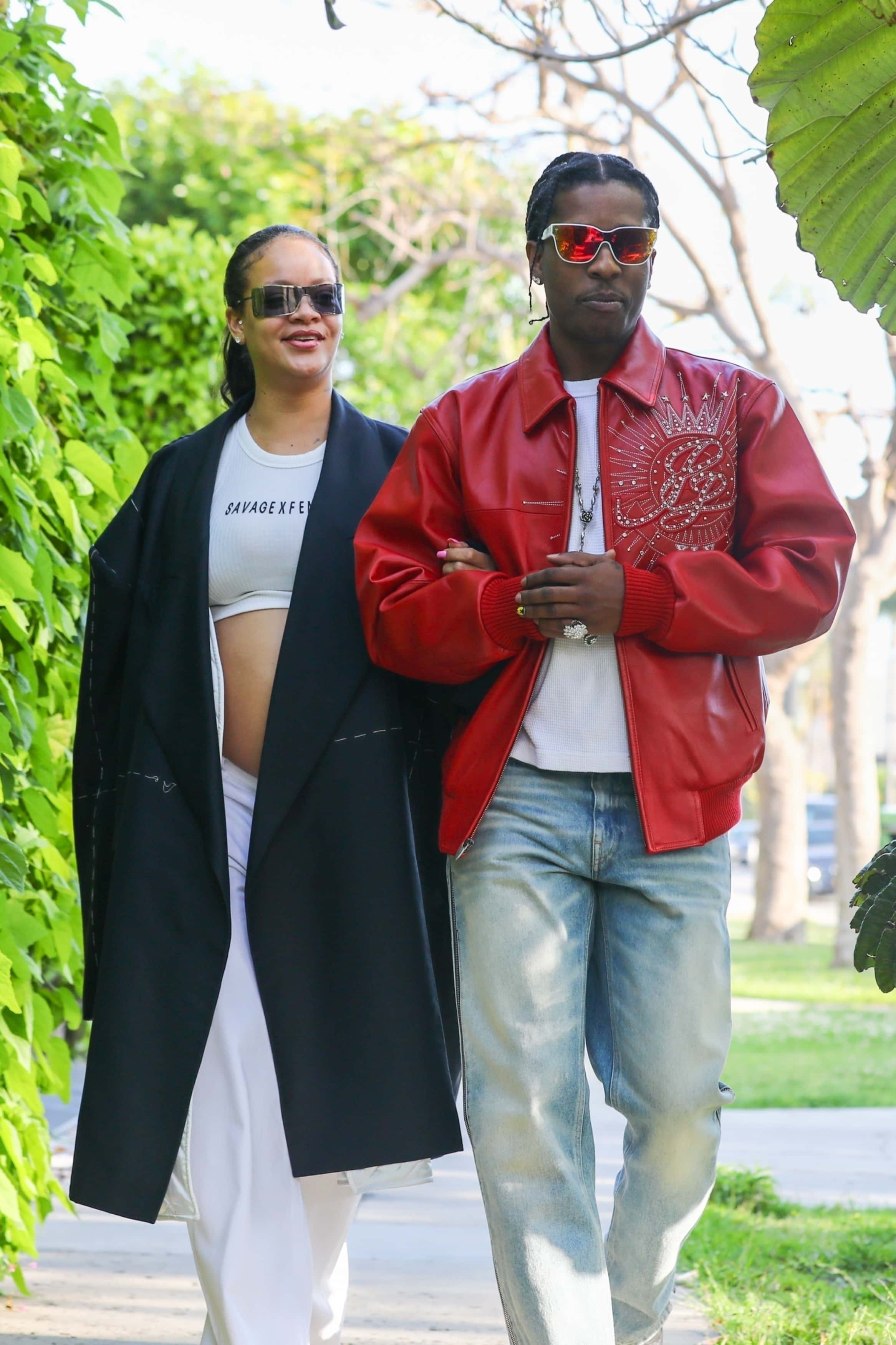 Rihanna looked sharp in a white crop top and oversized navy blazer while her partner, Rocky maintained his signature cool in a red leather jacket, blue trousers, black cowboy boots, and a pair of sunglasses (Backgrid)