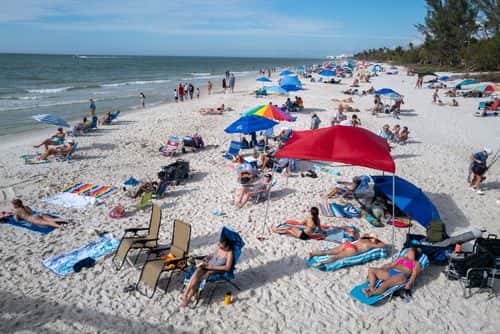 People enjoy an afternoon at a beach in Naples on November 23, 2022 in Naples, Florida. Despite continued closures and warnings at many Gulf of Mexico Florida beaches following the devastation brought by Hurricane Ian, tourists and locals have slowly been returning to beaches as they open. Thousands of Florida residents are still without housing and many more are dealing with repairs and debris clean-up after the historic hurricane brought wide scale devastation to the state.