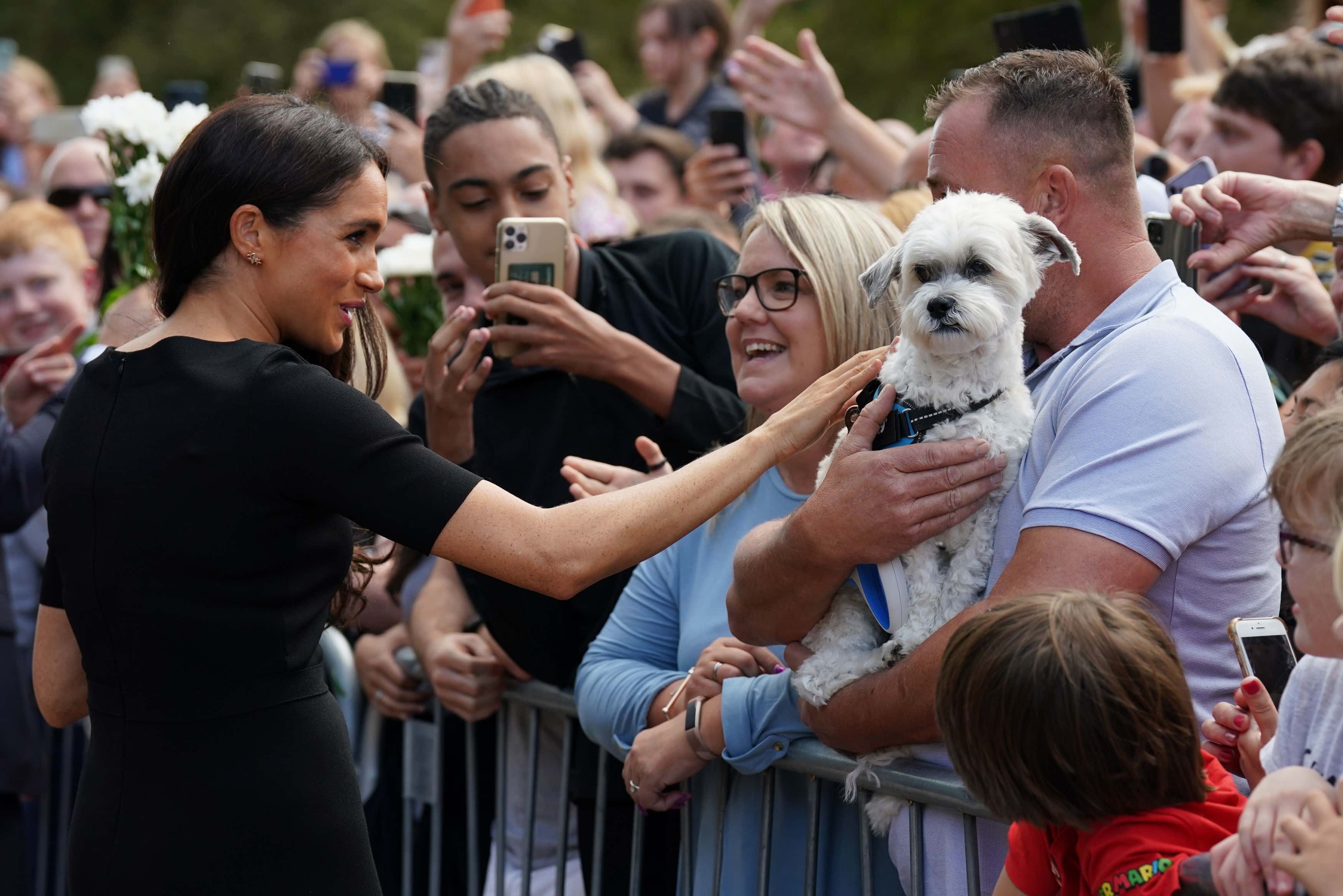 Meghan, Duchess of Sussex meet members of the public at Windsor Castle on September 10, 2022 in Windsor, England. Crowds have gathered and tributes left at the gates of Windsor Castle to Queen Elizabeth II, who died at Balmoral Castle on 8 September, 2022.
