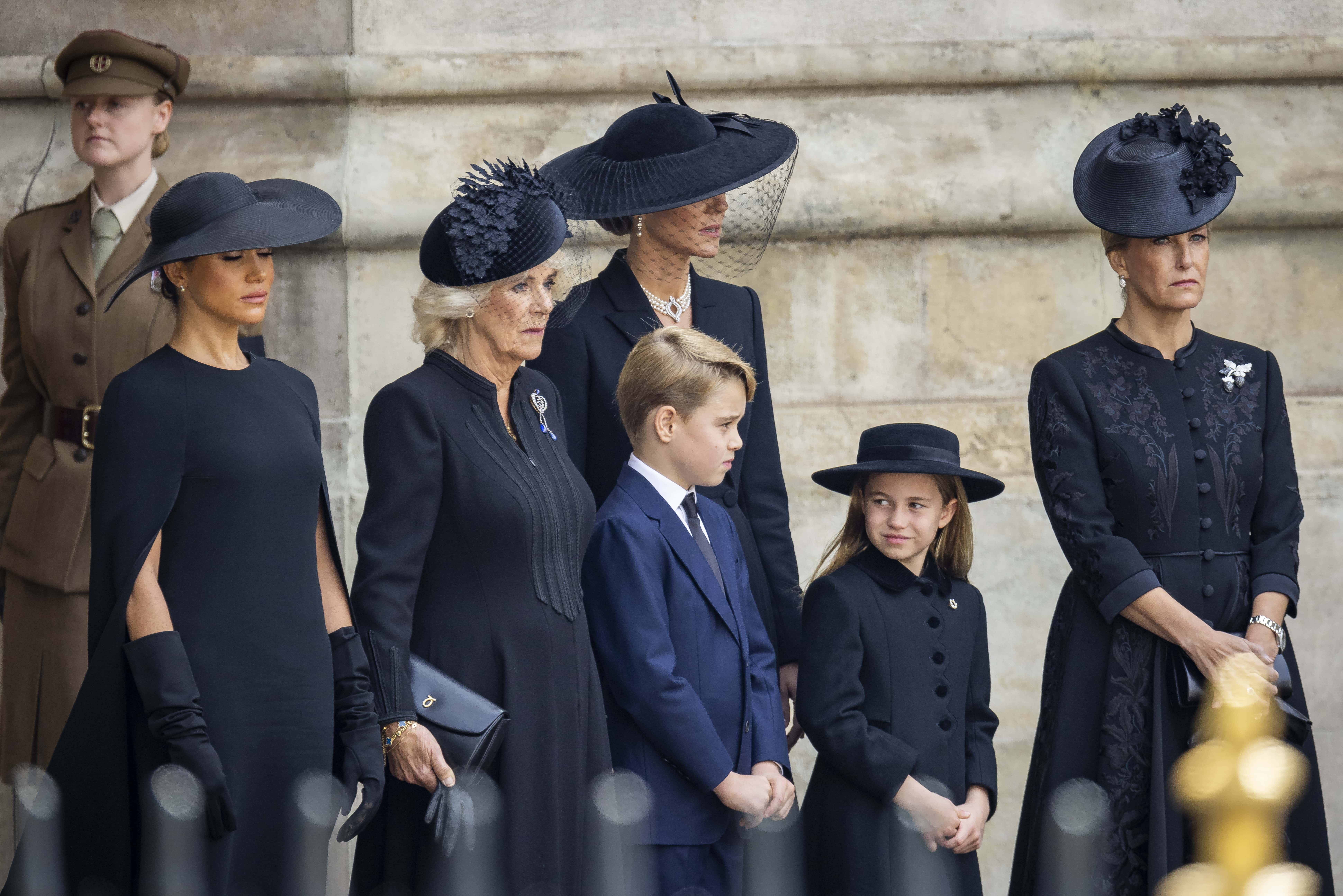 Meghan, Duchess of Sussex, Camilla, Queen Consort, Prince George of Wales, Catherine, Princess of Wales, Princess Charlotte of Wales and Sophie, Countess of Wessex look on after the state funeral of Queen Elizabeth II at Westminster Abbey on September 19, 2022 in London, England. Elizabeth Alexandra Mary Windsor was born in Bruton Street, Mayfair, London on 21 April 1926. She married Prince Philip in 1947 and ascended the throne of the United Kingdom and Commonwealth on 6 February 1952 after the death of her Father, King George VI. Queen Elizabeth II died at Balmoral Castle in Scotland on September 8, 2022, and is succeeded by her eldest son, King Charles III.
