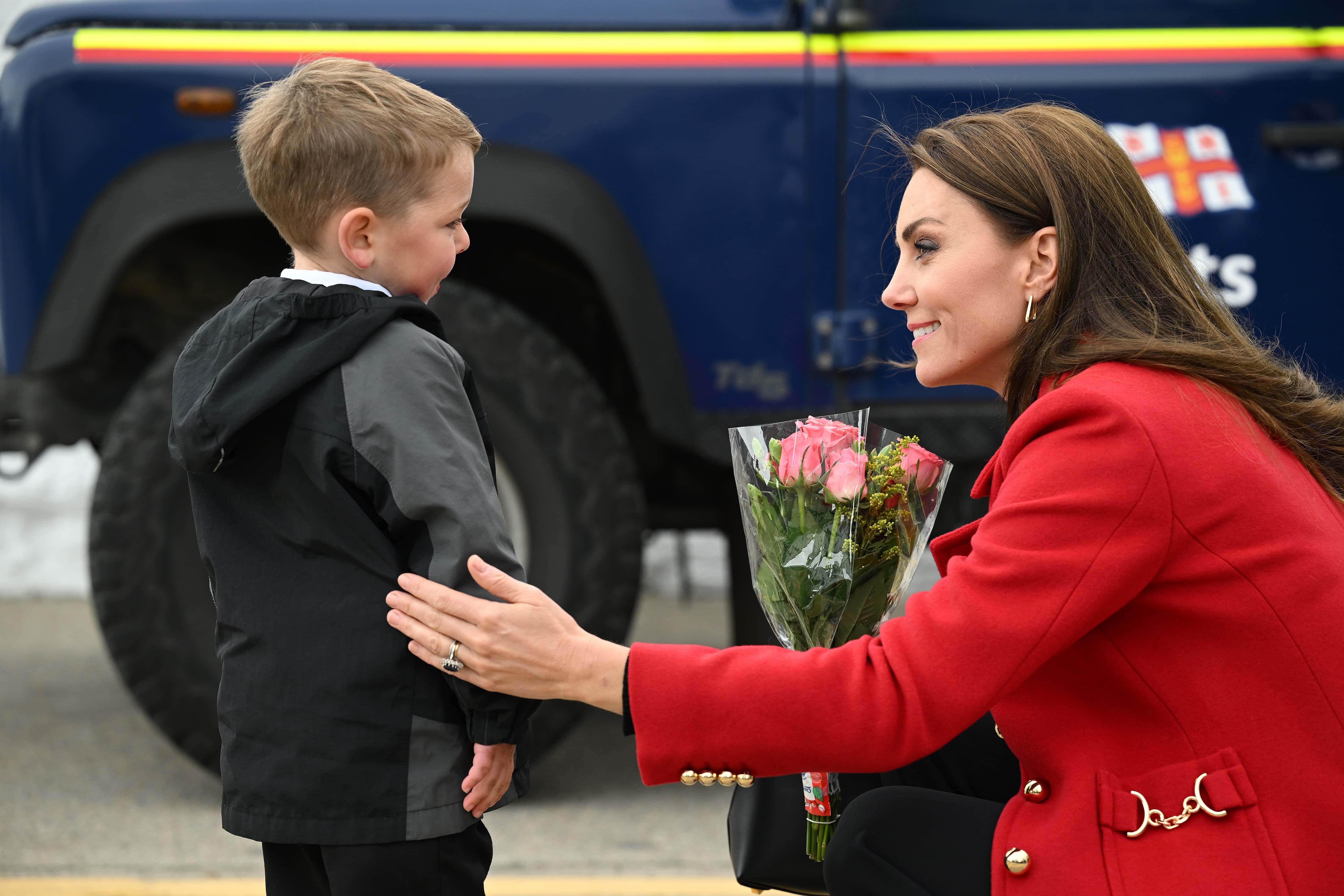 Britain's Catherine, Princess of Wales reacts as she is presented with a posy of flowers by four-year-old Theo Crompton during a visit to the RNLI (Royal National Lifeboat Institution) Holyhead Lifeboat Station in Anglesey, north west Wales on September 27, 2022 in Holyhead, Wales.