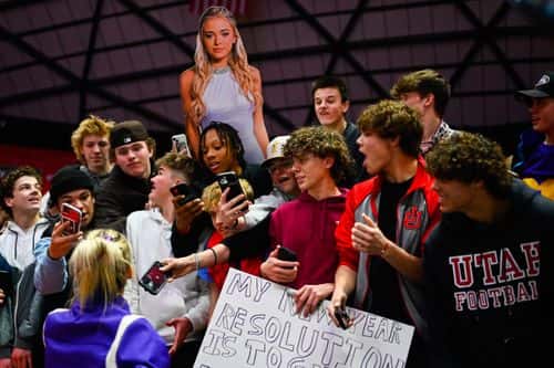 Olivia Dunne of LSU takes photos with fans after a PAC-12 meet against Utah at Jon M. Huntsman Center on January 06, 2023 in Salt Lake City, Utah.