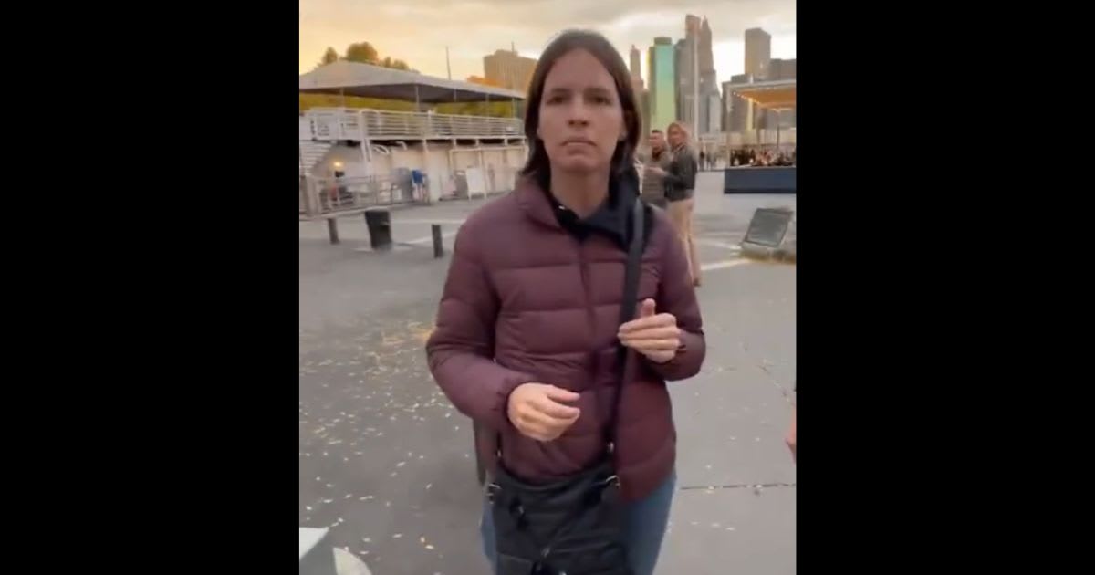 Kelly Ann, who's seen clutching the torn posters in her hand, was with her husband Noah Schaffer when the video was filmed. (@StopAntisemites/X)