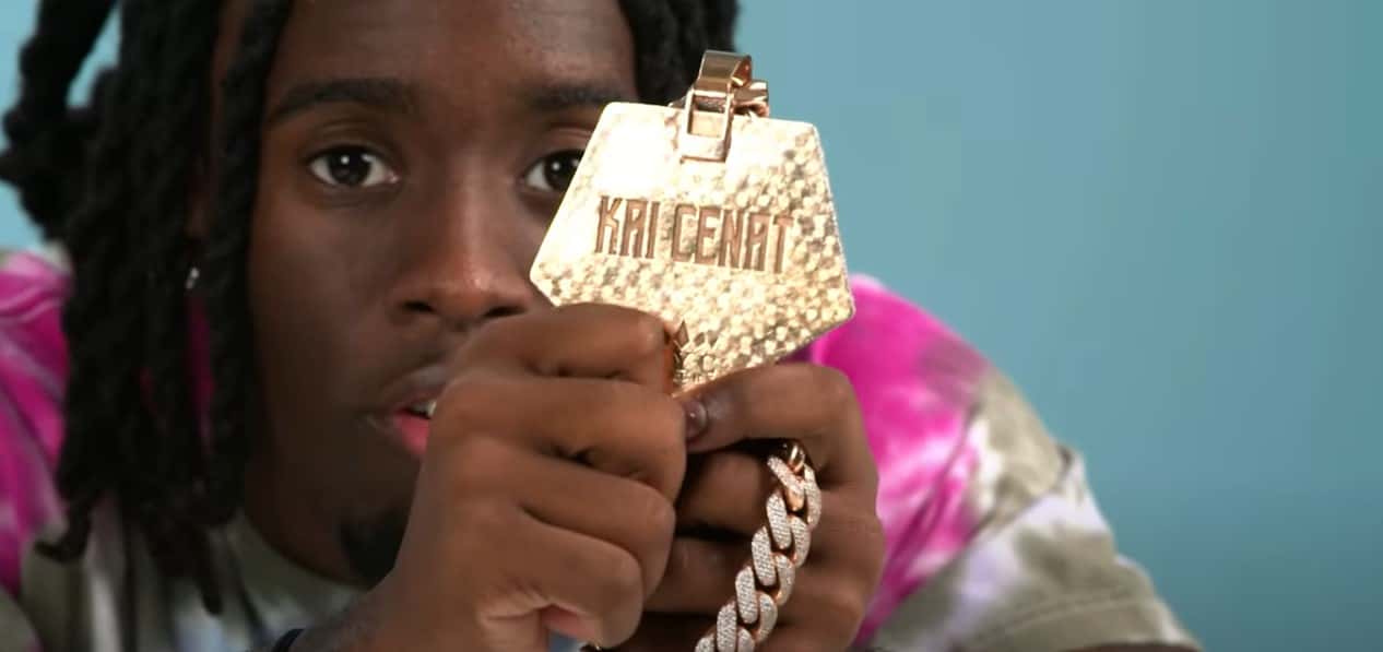 Kai Cenat showing his jewelry (GQ/YouTube)