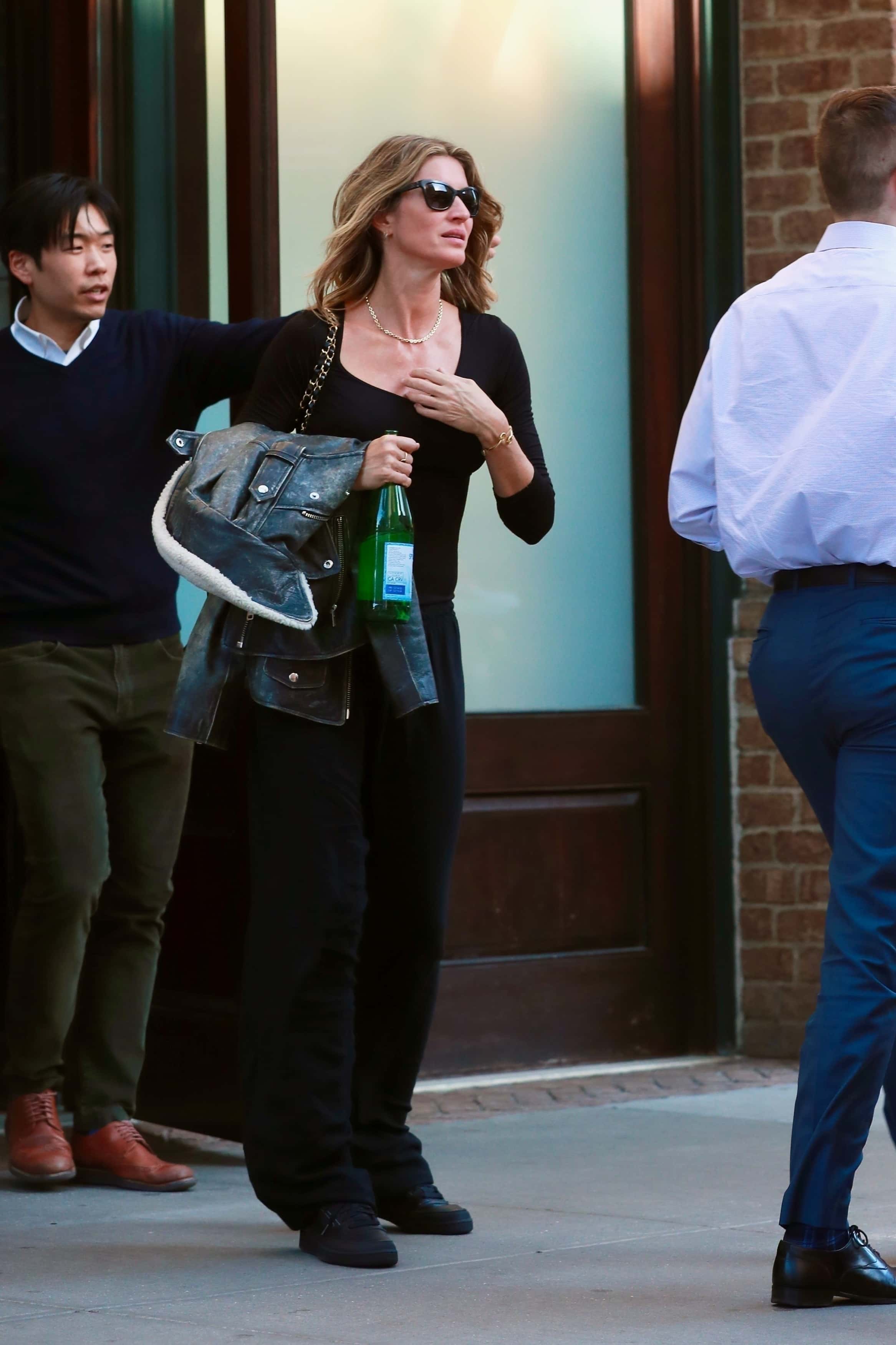 The Vogue cover girl donned a faded leather jacket over a plain black top and pants (backgrid)