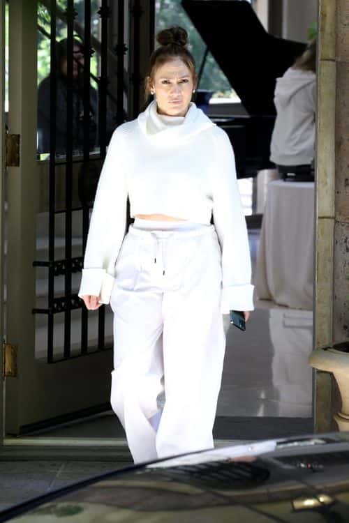 Jennifer Lopez looked casual yet stylish as she wore a large white sweater with ribbed detailing while going house-hunting in LA (Backgrid)