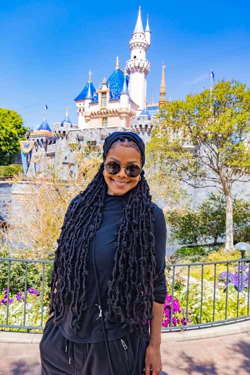 In this handout photo provided by Disneyland Resort, Janet Jackson poses at Sleeping Beauty Castle at Disneyland Park while vacationing with friends and family at Disneyland Resort March 30, 2022 in Anaheim, California.