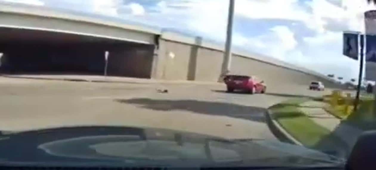 The red SUV turned a corner when the child suddenly fell off