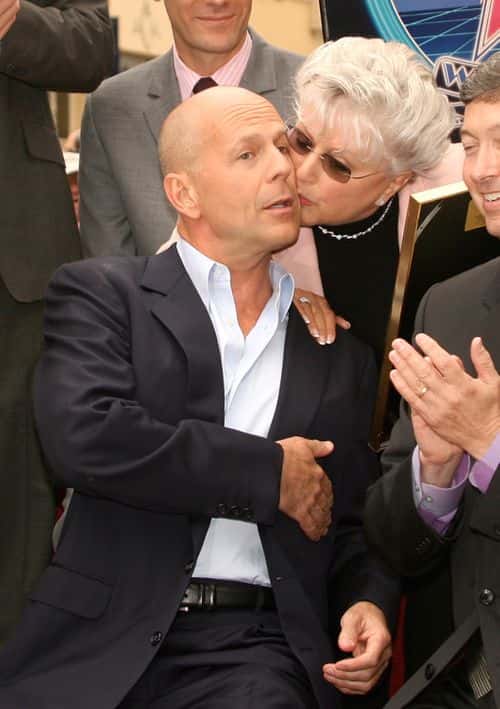 Actor Bruce Willis gets a kiss from Marlene WIllis during his Hollywood Walk of Fame ceremony on October 16, 2006 in Hollywood, California.