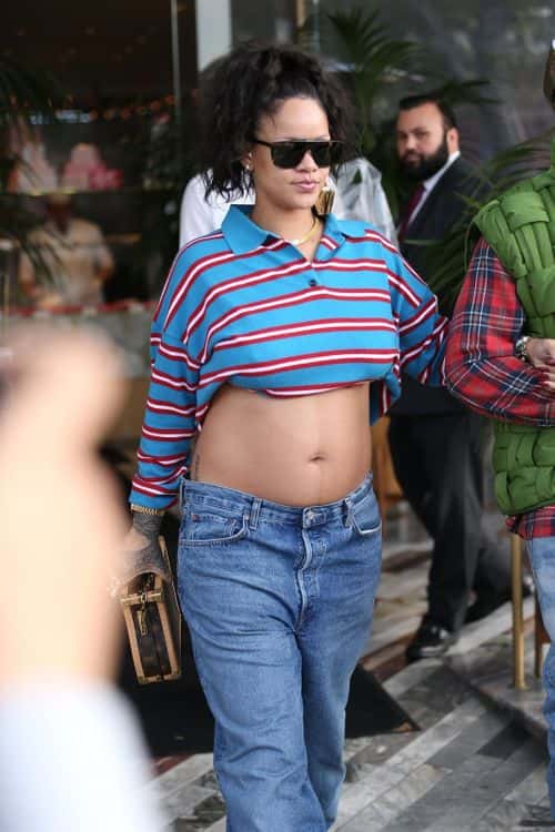 Riri gripped a Louis Vuitton clutch and accessorised with dark shades and a gold watch to complete her look (Backgrid)