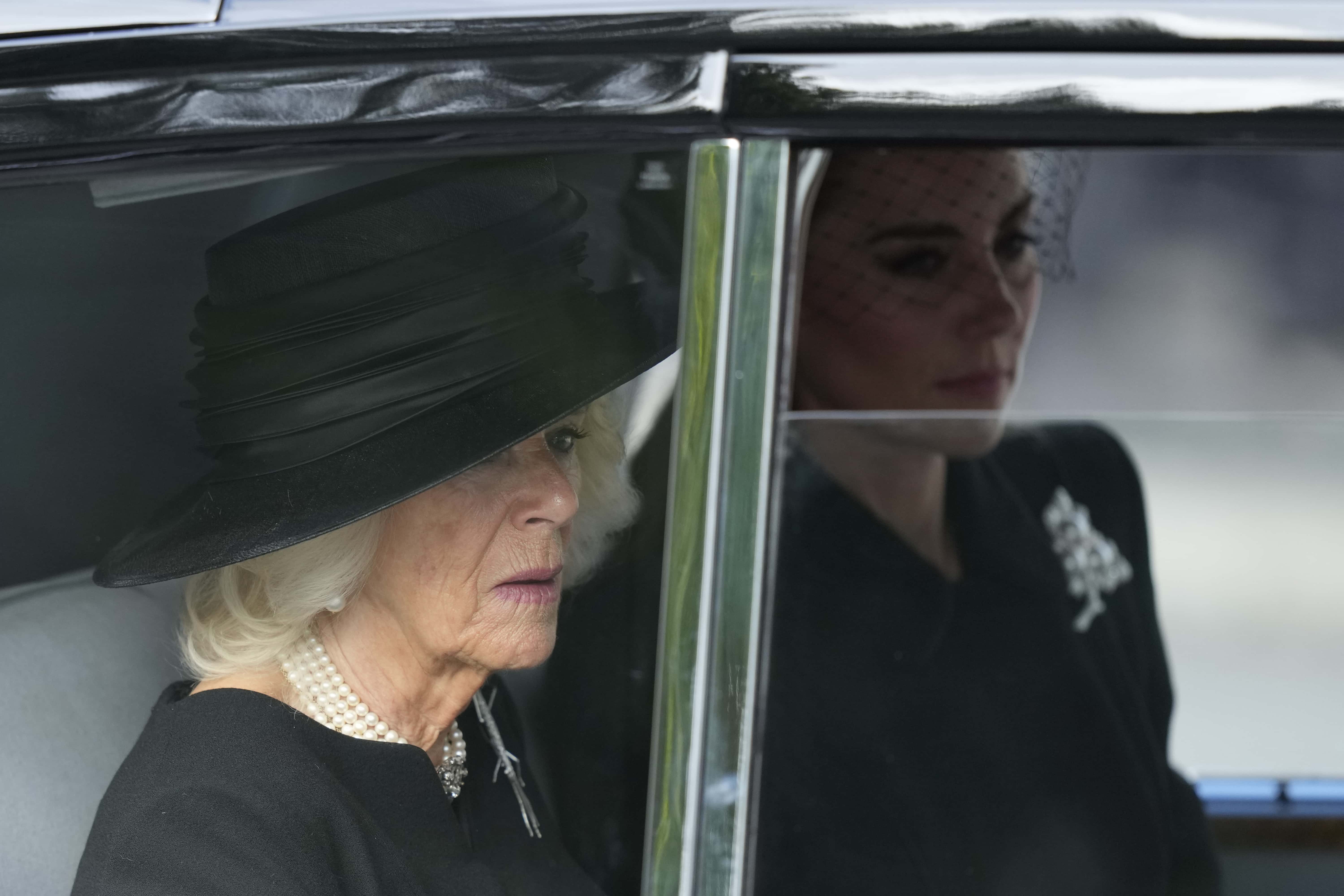 (L-R) Camilla, Queen Consort and Catherine, Princess of Wales, depart Buckingham Palace as the coffin of Queen Elizabeth II, adorned with a Royal Standard and the Imperial State Crown is pulled by a Gun Carriage of The King's Troop Royal Horse Artillery, during a procession from Buckingham Palace to Westminster Hall on September 14, 2022 in London, United Kingdom. Queen Elizabeth II's coffin is taken in procession on a Gun Carriage of The King's Troop Royal Horse Artillery from Buckingham Palace to Westminster Hall where she will lay in state until the early morning of her funeral. Queen Elizabeth II died at Balmoral Castle in Scotland on September 8, 2022, and is succeeded by her eldest son, King Charles III.