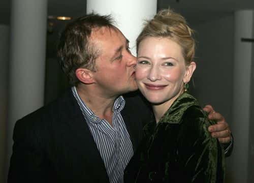 Actress Cate Blanchett is kissed by her director husband, Andrew Upton as they arrive during the opening night party for 