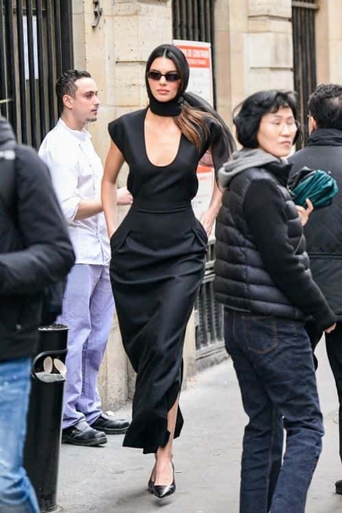 Flaunting her svelte physique, the model slipped into the classy black dress with a plunging rounded neckline and a full-length skirt (Backgrid)