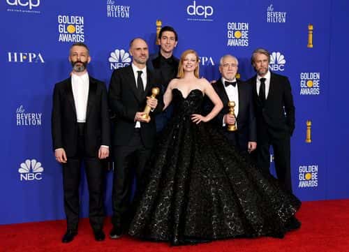 (L-R) Jeremy Strong, Jesse Armstrong,  Nicholas Braun, Sarah Snook, Alan Ruck, and  Brian Cox pose with the award for BEST TELEVISION SERIES - DRAMA for 