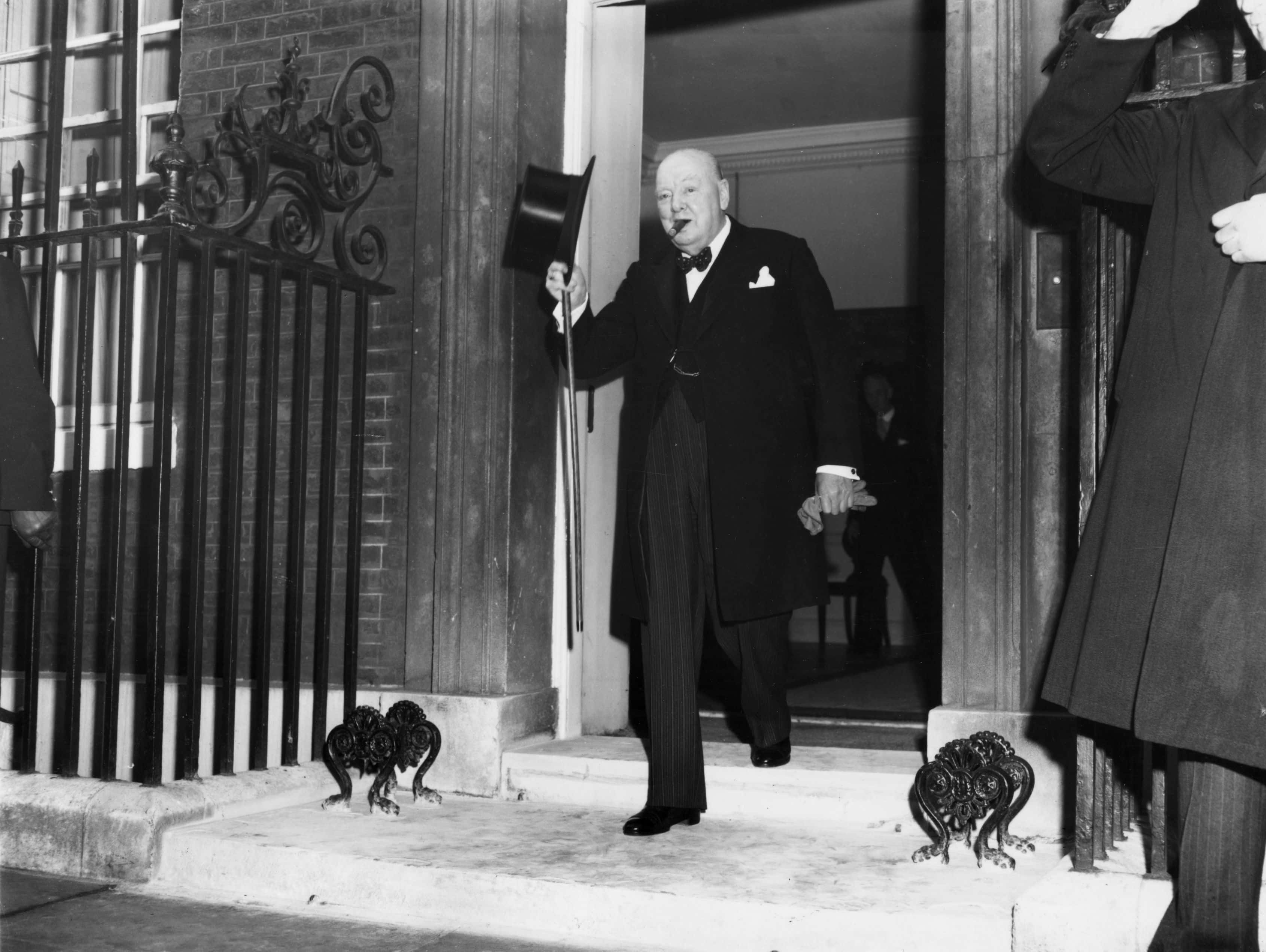 British prime minister Sir WInston Churchill (1874-1965) leaves his residence at Number 10, Downing Street, London, to visit Queen Elizabeth II and tender his resignation. His latter years were spent quietly in the pursuit of art and literature.