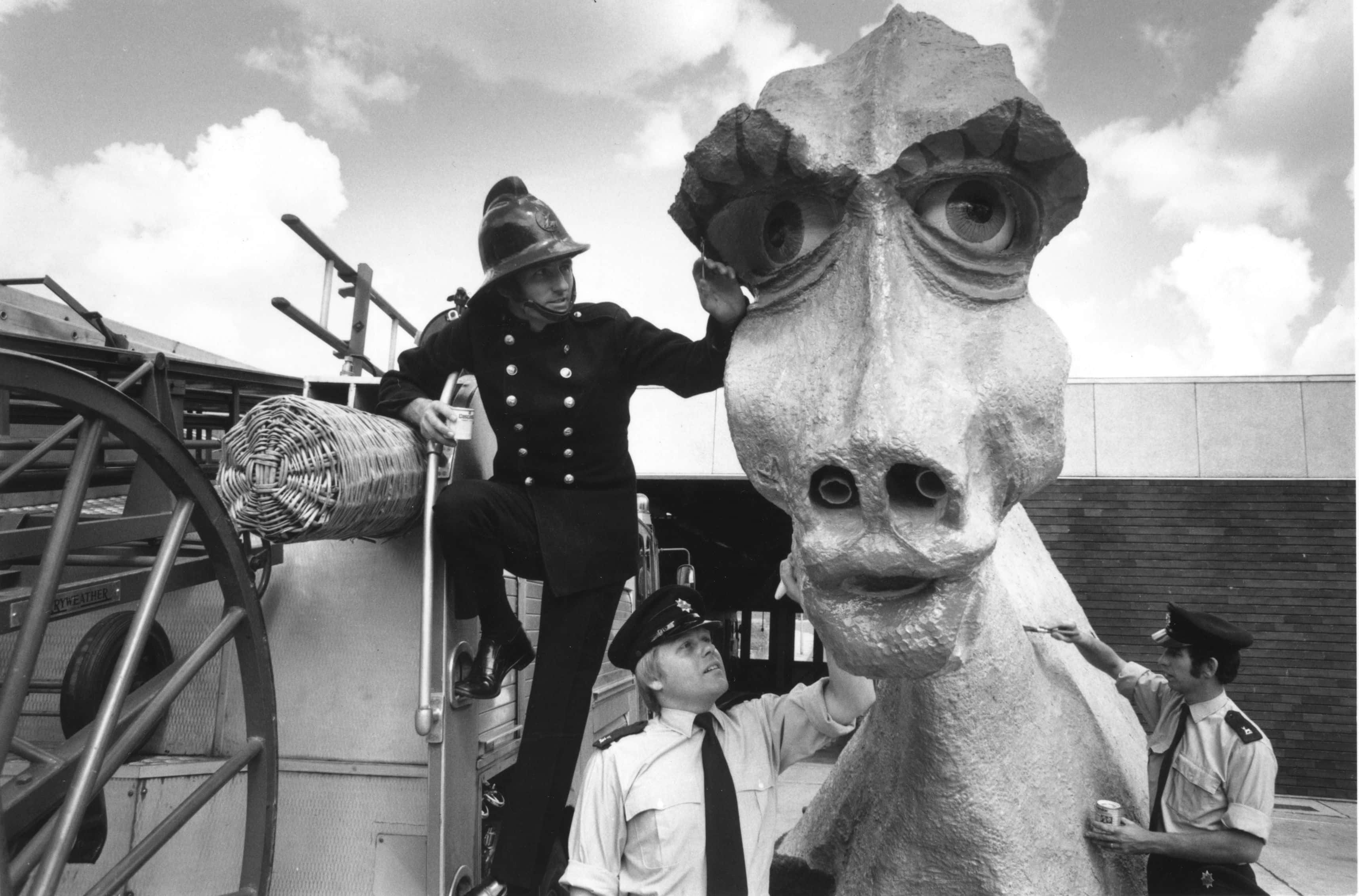 Firemen from Hemel Hempstead, London, adding the finishing touches to a seductive female Nessie, intended to lure the Loch Ness Monster from his Scottish depths. The beautiful beast is 30ft long, 14ft high and 10ft wide and is made from oil drums and paper mache. She has an amplified mating call, can puff smoke through her nostrils, and carries a hidden camera to record the momentous meeting. The project is in aid of the Fire Service Benevolent Fund.