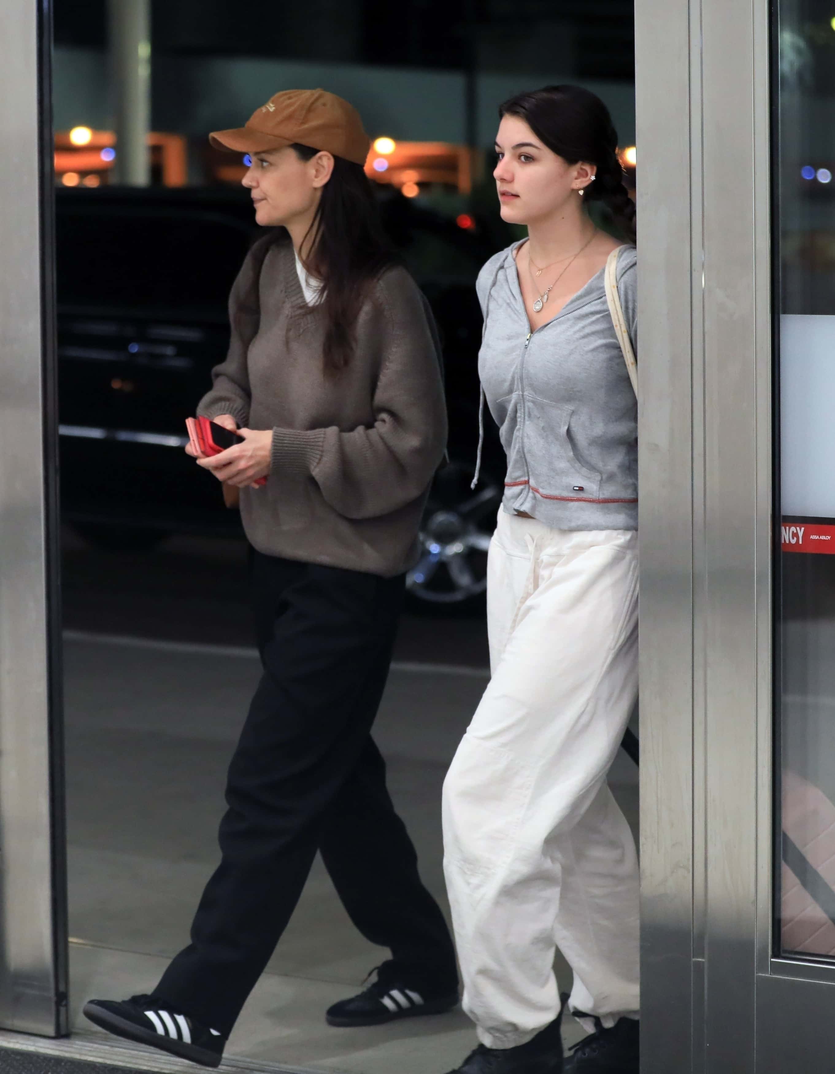 Katie Holmes' daughter Suri Cruise was the spitting image of her mother on their latest outing as they jetted out of Los Angeles on Monday night (backgrid)