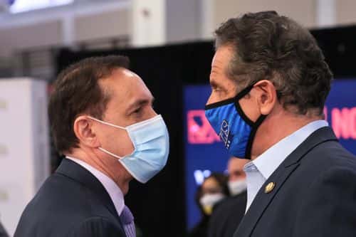Dr. Howard A. Zucker, commissioner of the New York State Department of Health, and Gov. Andrew Cuomo have a conversation after the conclusion of a press conference on coronavirus (COVID-19) vaccination at Suffolk County Community College on April 12, 2021 in Brentwood, New York. Gov. Andrew Cuomo held a press conference at Suffolk County Community College, a mass vaccination site, announcing that the state will be sending the coronavirus (COVID-19) vaccine to colleges and universities across New York to encourage college students to get vaccinated before heading home for the summer.