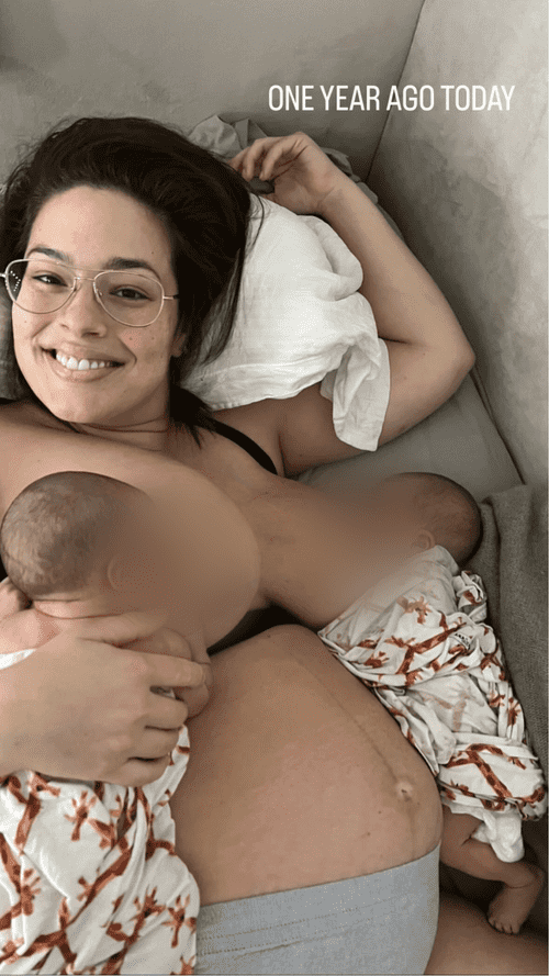 The wholesome snap captured Graham beaming up at the camera as she rested on the couch with both new-borns swaddled on either side of her.  (Ashley Graham/Instagram)