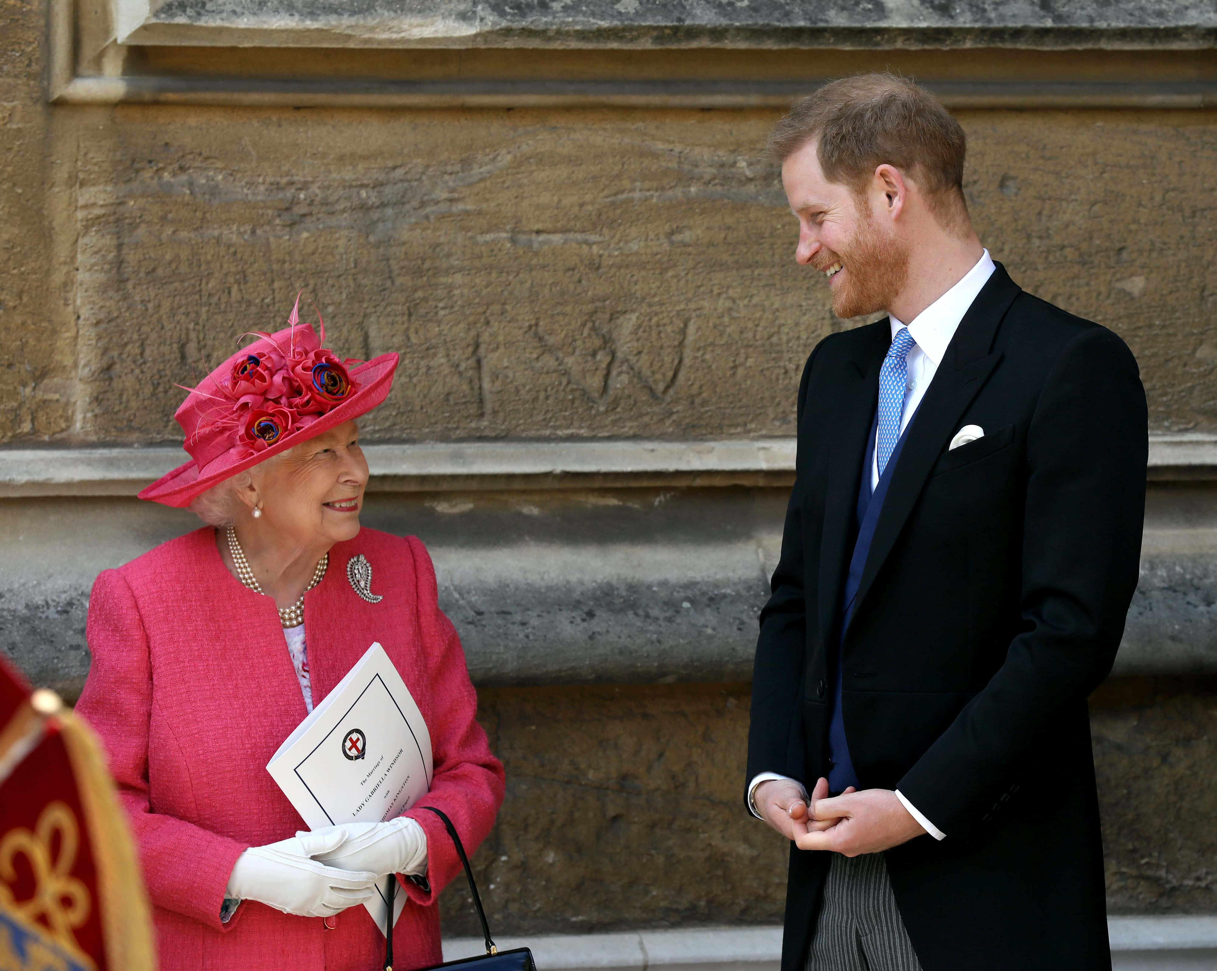 Queen Elizabeth II speaks with Prince Harry, Duke of Sussex as they leave after the wedding of Lady Gabriella Windsor to Thomas Kingston at St George's Chapel, Windsor Castle on May 18, 2019 in Windsor, England.