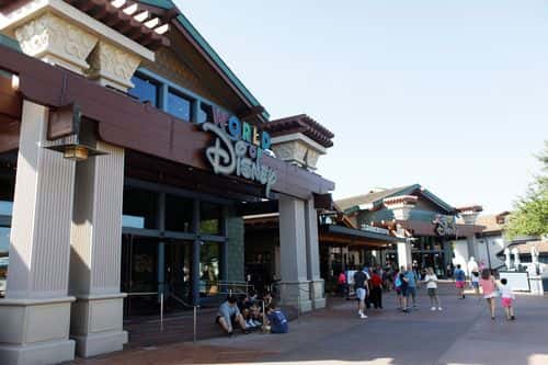 Tourists walk through Disney Springs at Walt Disney World on March 22, 2022 in Orlando, Florida. Employees are staging a company-wide walkout today to protest Walt Disney Co.'s response to controversial legislation passed in Florida known as the “Don’t Say Gay” bill.