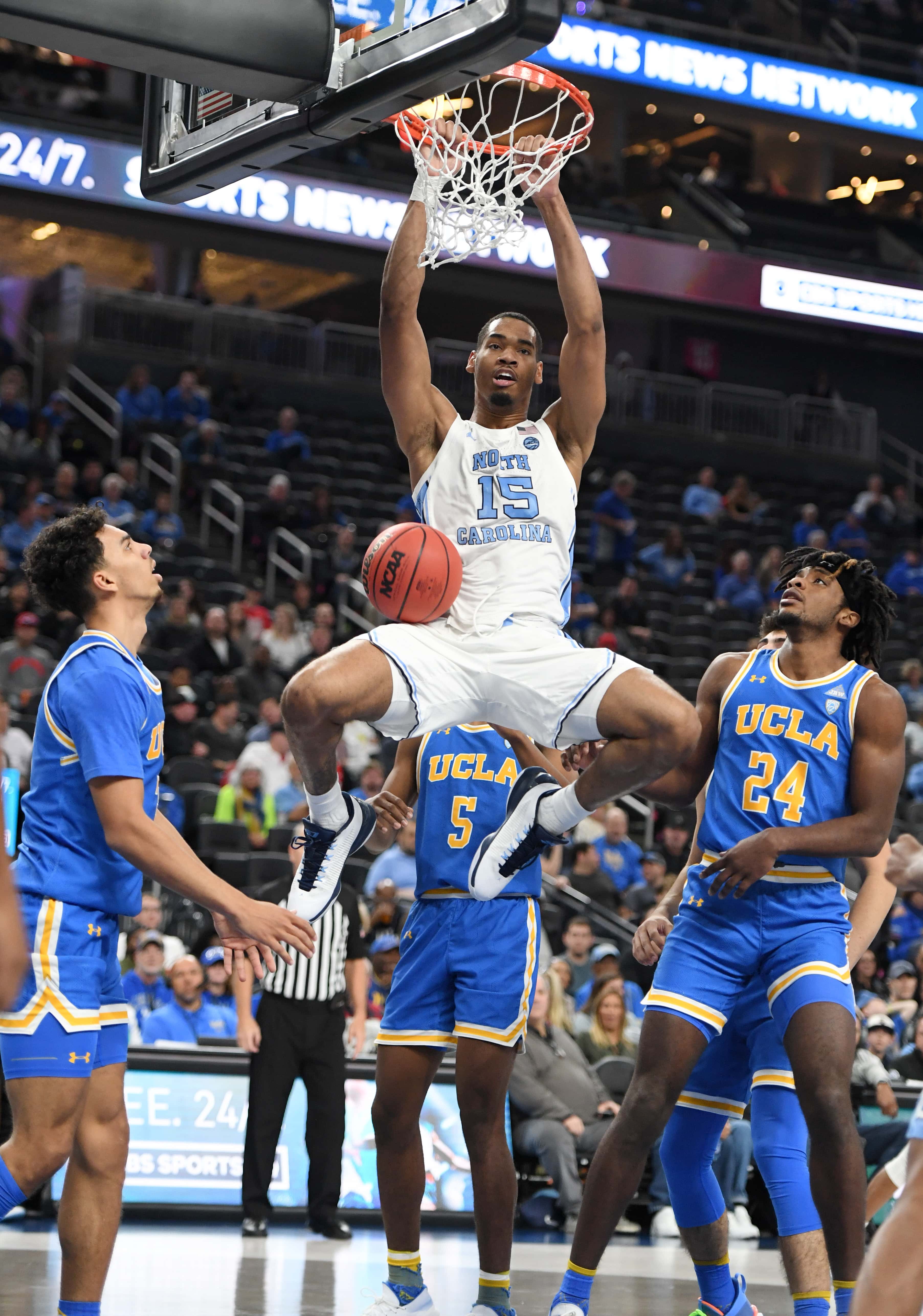 Garrison Brooks #15 of the North Carolina Tar Heels dunks against Jules Bernard #3 and Jalen Hill #24 of the UCLA Bruins during the CBS Sports Classic at T-Mobile Arena on December 21, 2019 in Las Vegas, Nevada.