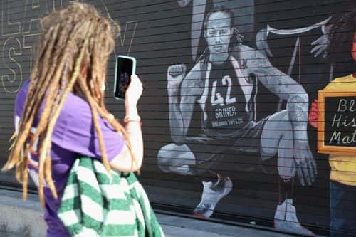 Phoenix Mercury fan Carley Givens takes a photo of a