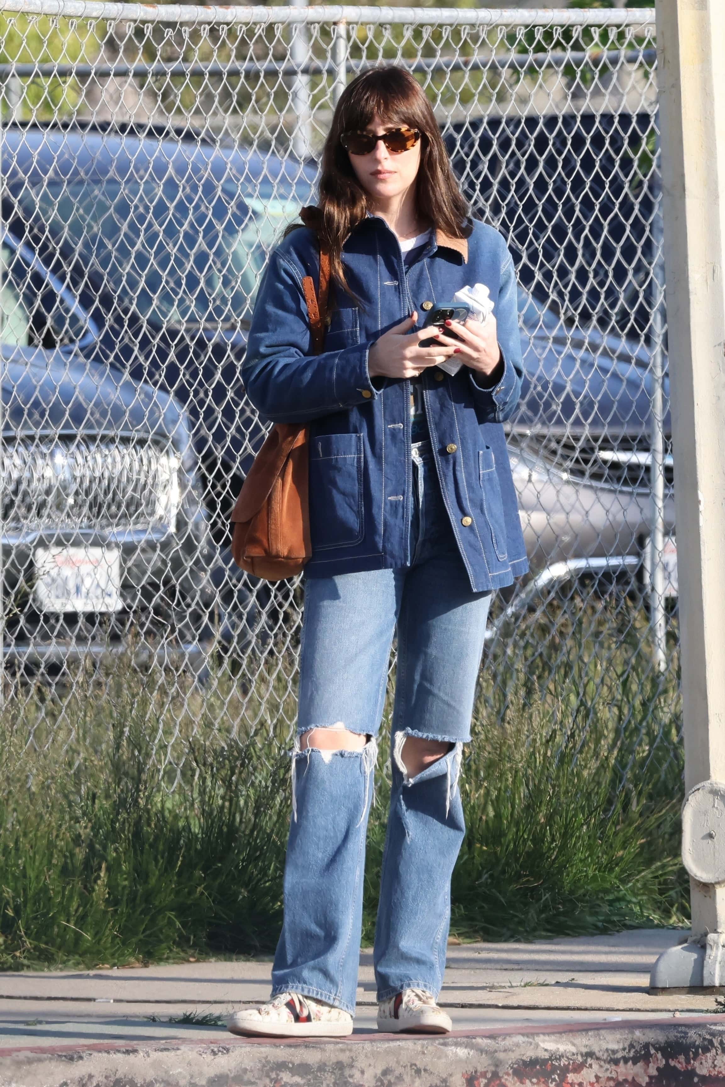 Dakota carried a water bottle with her perfectly manicured hands, all done up with a slick of red polish upon her nails (Backgrid)