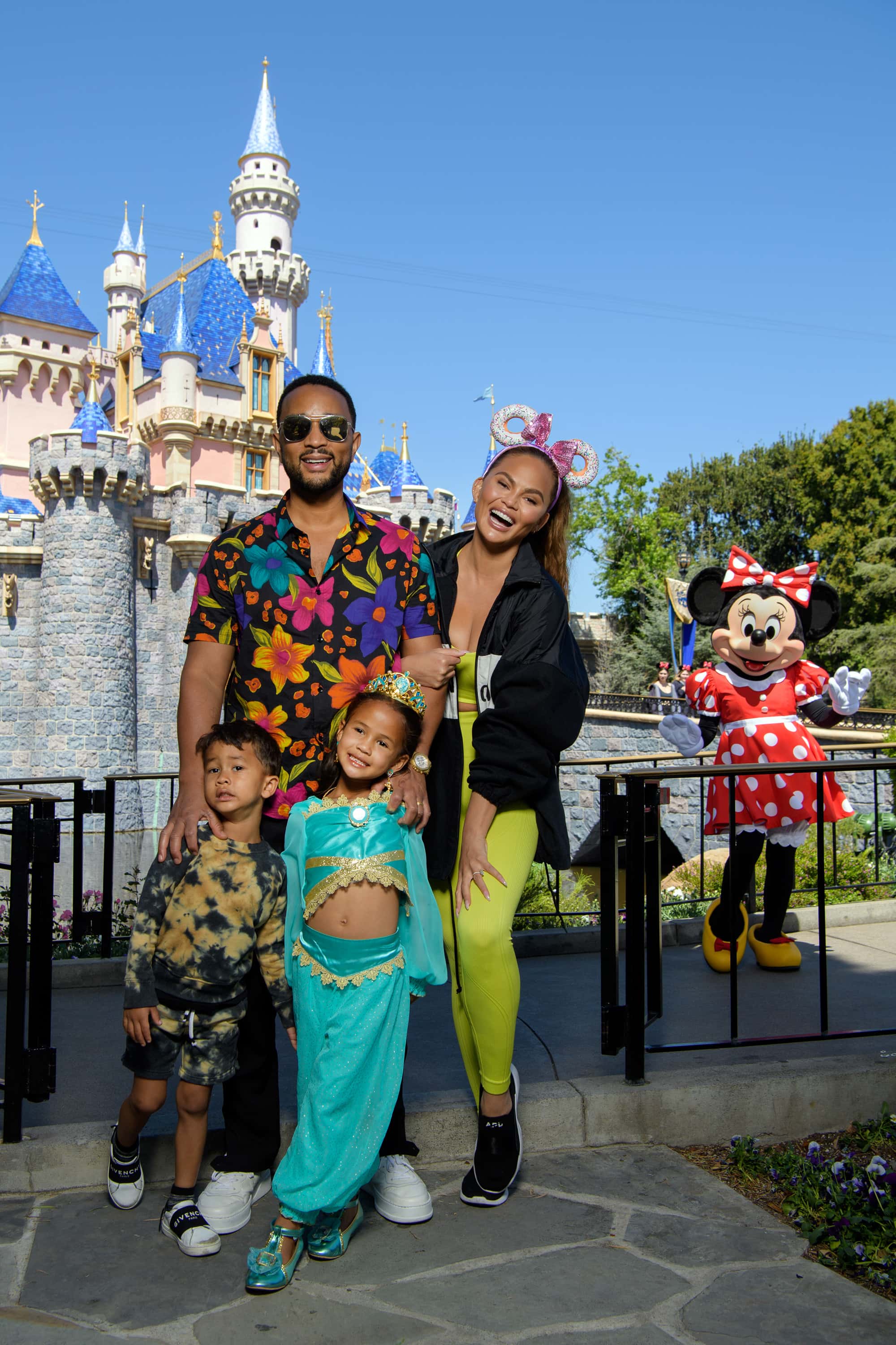 In this handout photo provided by Disneyland Resort, John Legend, Chrissy Teigen and their children, Miles and Luna pose with Minnie Mouse while celebrating Luna’s birthday at Disneyland on April 14, 2022 in Anaheim, California.