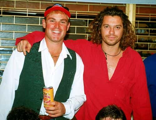 (L-R) Australian cricketer Shane Warne poses for a photo with Michael Hutchence, lead singer of INXS July, 1993 in London, England.