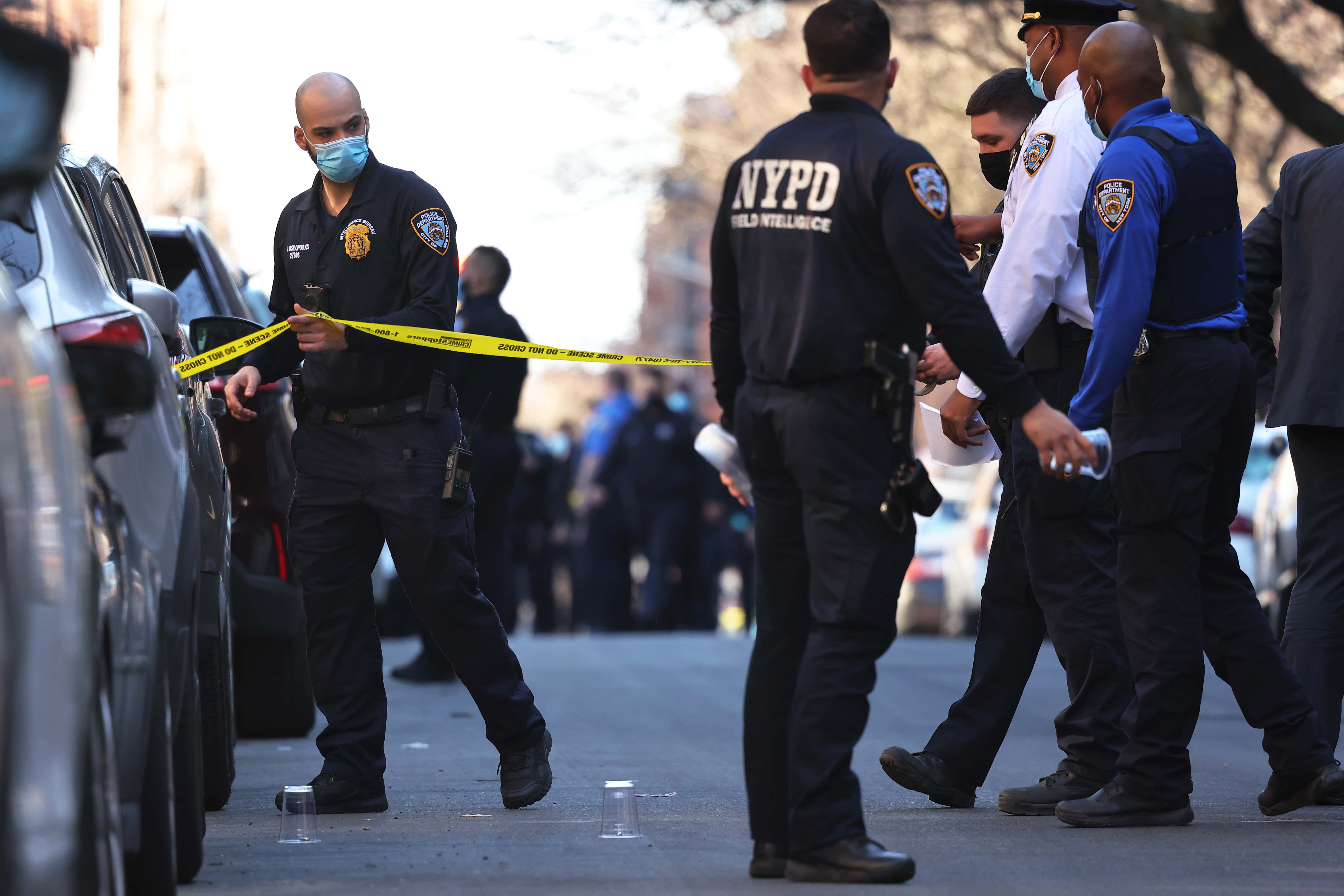 NYPD officers respond to the scene of a shooting that left multiple people injured in the Flatbush neighborhood of the Brooklyn borough on April 06, 2021 in New York City. So far this year New York City has seen a 40% rise in shootings over the same period in 2020.