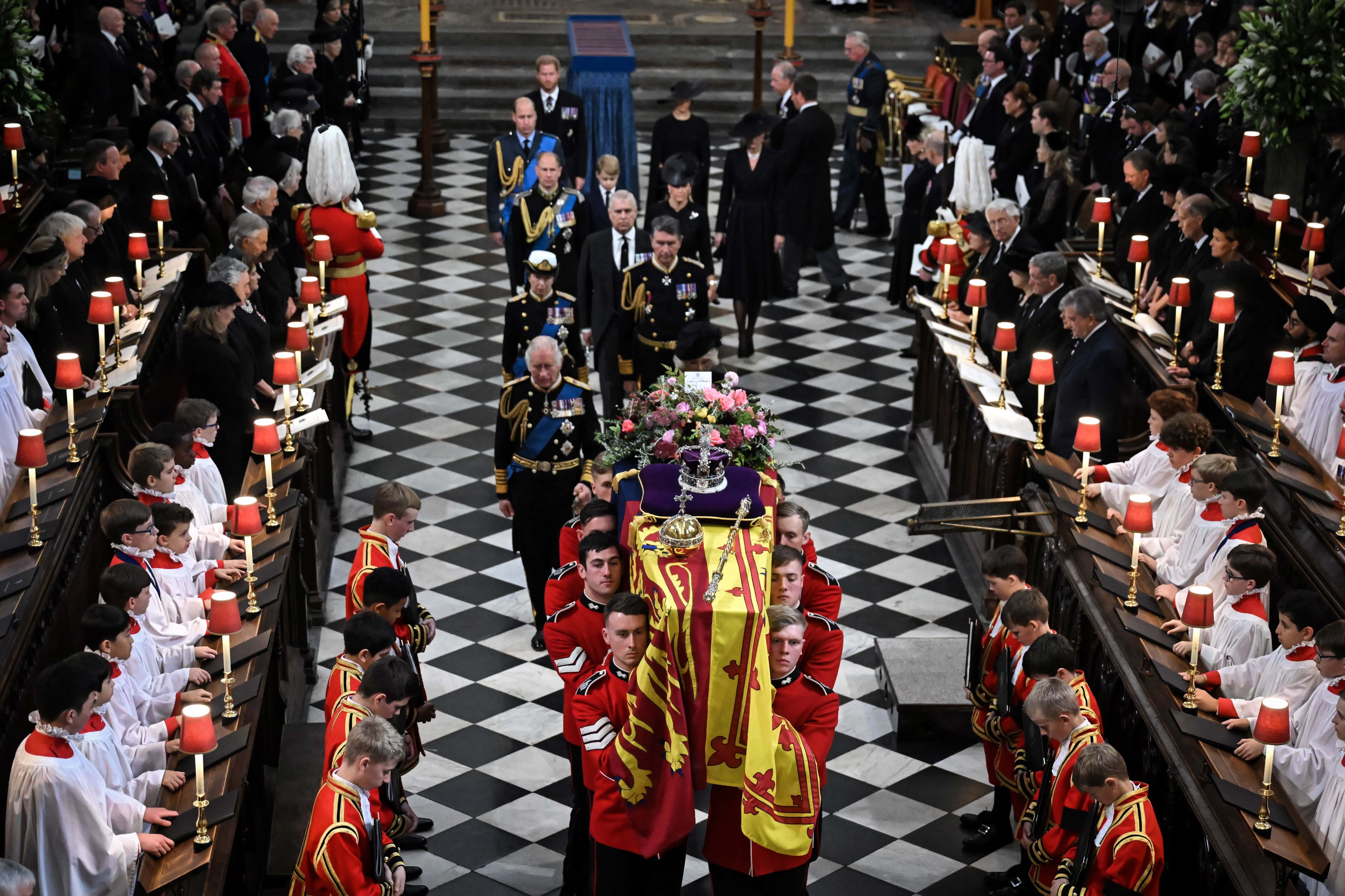 Britain's King Charles III (L), Britain's Camilla, Queen Consort, Britain's Princess Anne, Princess Royal, Vice Admiral Timothy Laurence, Britain's Prince Andrew, Duke of York, Britain's Prince Edward, Earl of Wessex, Britain's Sophie, Countess of Wessex, Britain's Prince William, Prince of Wales, Britain's Prince George of Wales, Britain's Catherine, Princess of Wales, Britain's Prince Harry, Duke of Sussex and Britain's Meghan, Duchess of Sussex walk behind the coffin of Britain's Queen Elizabeth II as they leave Westminster Abbey on September 19, 2022 in London, England. Elizabeth Alexandra Mary Windsor was born in Bruton Street, Mayfair, London on 21 April 1926. She married Prince Philip in 1947 and ascended the throne of the United Kingdom and Commonwealth on 6 February 1952 after the death of her Father, King George VI. Queen Elizabeth II died at Balmoral Castle in Scotland on September 8, 2022, and is succeeded by her eldest son, King Charles III. (Photo by Ben Stansall - WPA Pool/Getty Images)