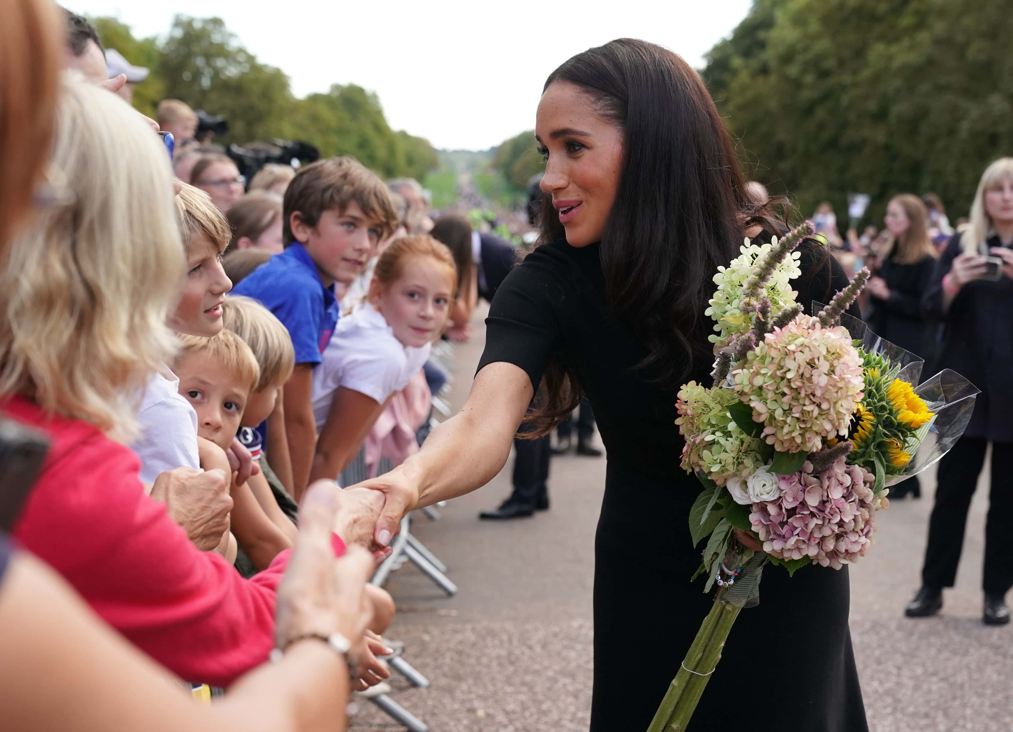 Meghan, Duchess of Sussex meet members of the public at Windsor Castle on September 10, 2022 in Windsor, England. Crowds have gathered and tributes left at the gates of Windsor Castle to Queen Elizabeth II, who died at Balmoral Castle on 8 September, 2022.