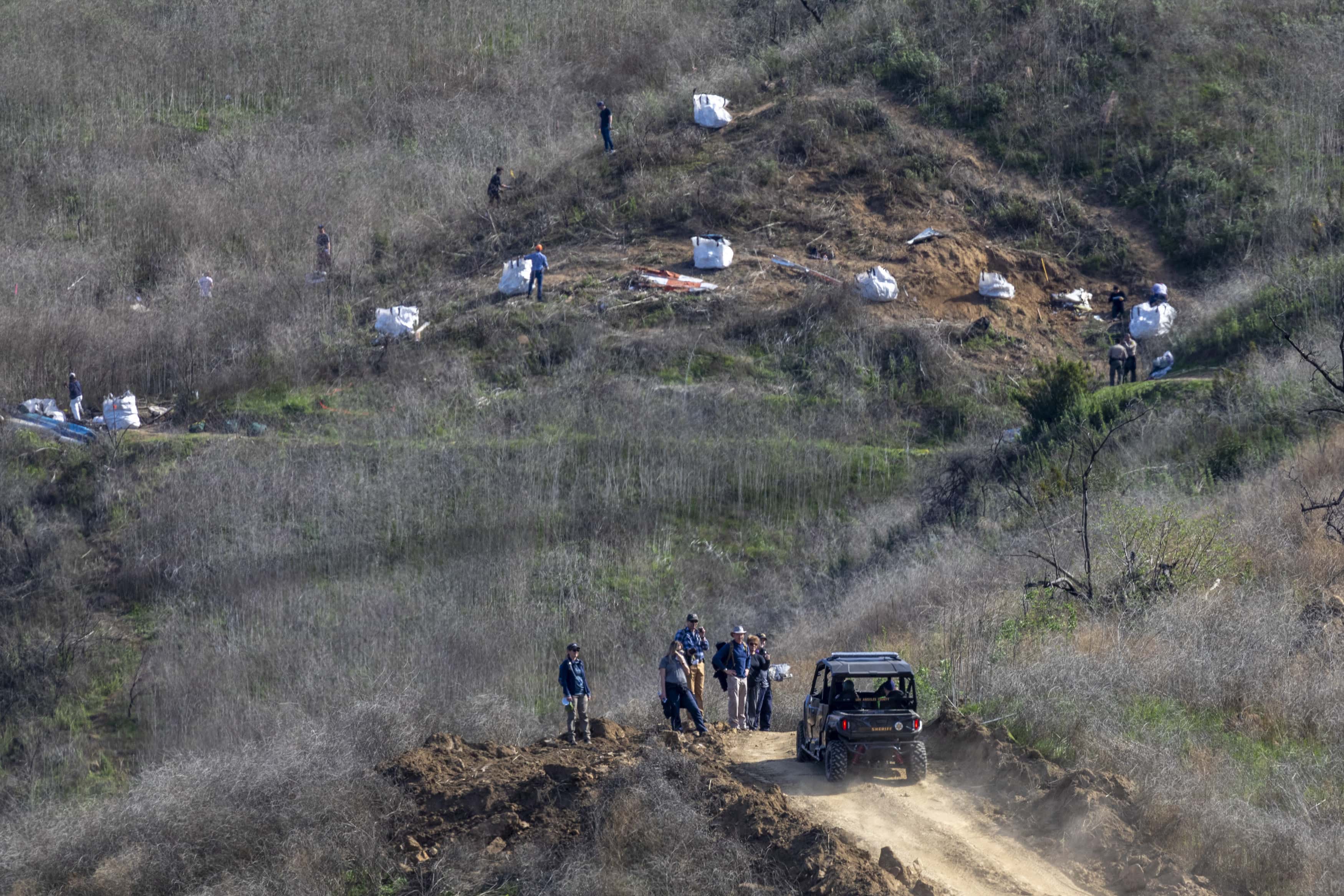Investigators work at the scene of the helicopter crash, where former NBA star Kobe Bryant and his 13-year-old daughter Gianna died, on January 28, 2020 in Calabasas, California. Kobe and