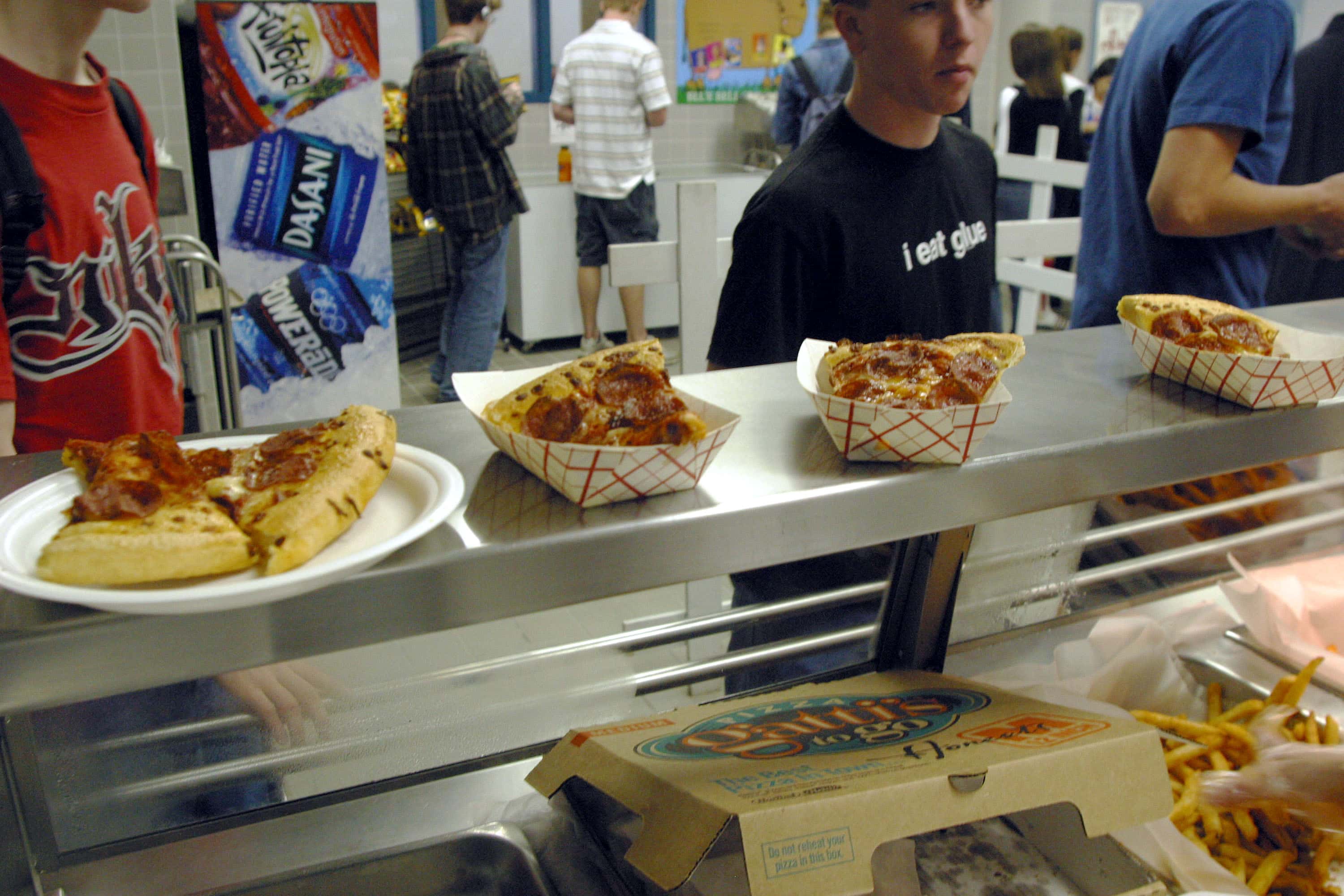 Students line up to receive food during lunch in the cafeteria at Bowie High School  March 11, 2004  in Austin, Texas. The Austin School District is working to make their cafeteria offerings more healthy, but the most  popular foods are still fried chicken strips, pizza, and french fries. Concern about increased levels of childhood obesity in the United States has made the food served in public schools cafeterias a much greater concern.