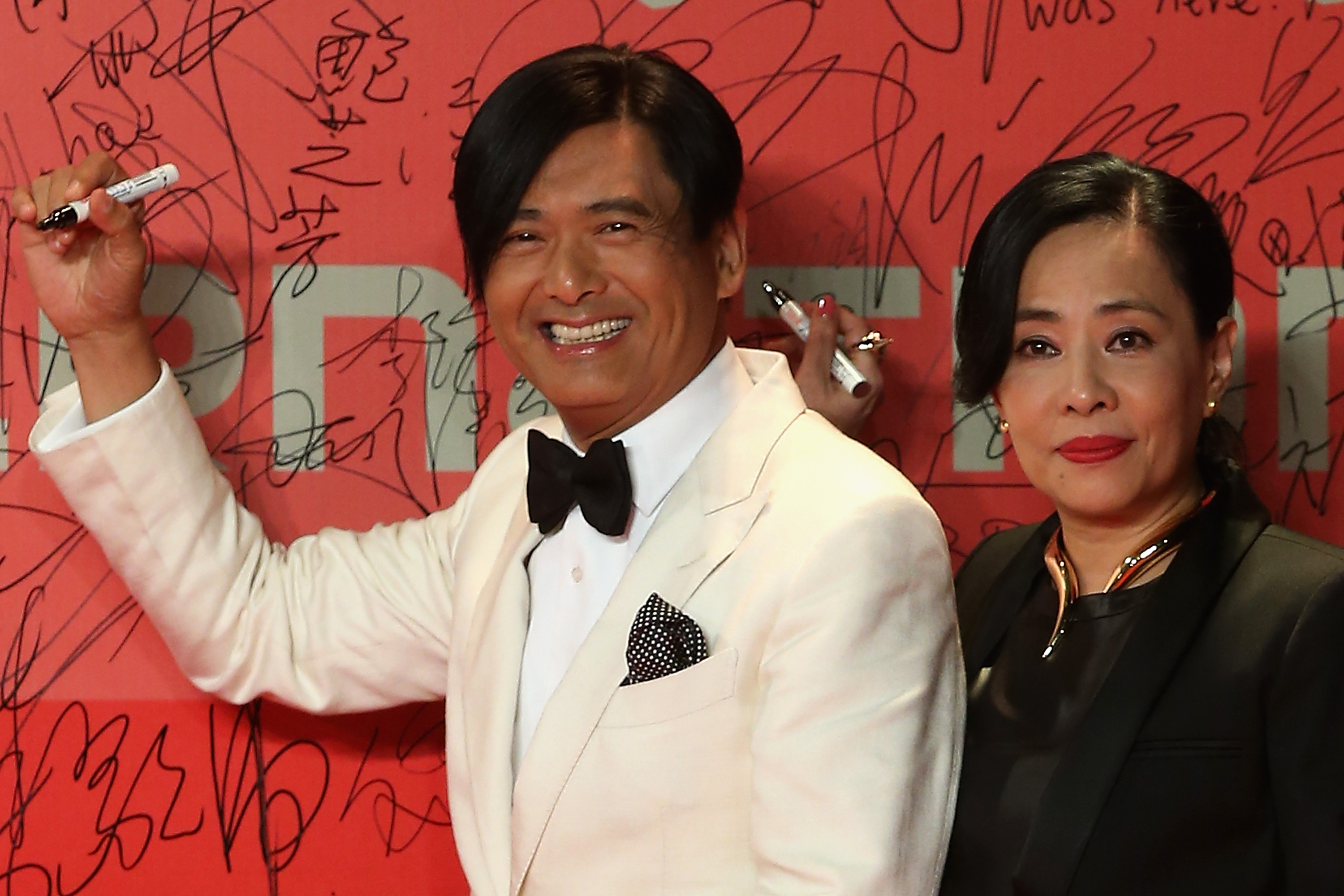 Hong Kong actor Chow Yun fat and his wife Idy Chan arrive at the opening ceremony of the 16th Shanghai International Film Festival at Shanghai Culture Square on June 15, 2013 in Shanghai, China.