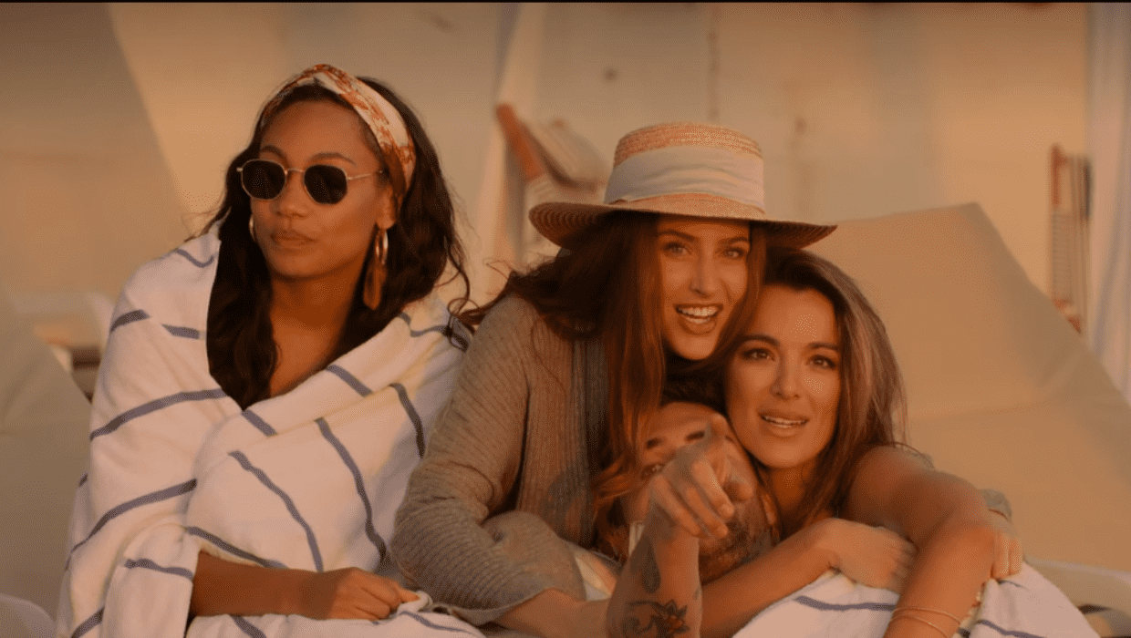 Tyler cozing up with Paula and Alex at the beach in 'Selling The OC' (Netflix)