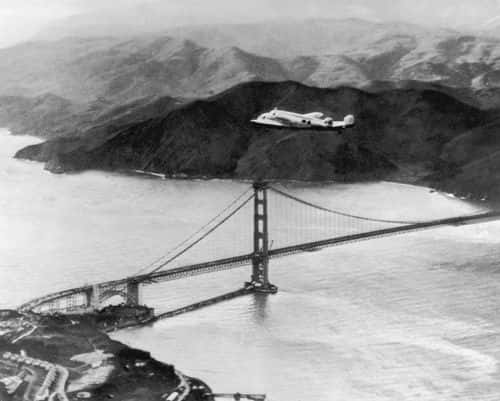 The Lockheed Electra 'Flying Laboratory', piloted by American aviator Amelia Earhart (1898  - 1937) and Fred Noonan flies over the Golden Gate bridge in Oakland, California, at the start of a planned round-the-world flight, 17th March 1937. The trip had to be abandoned after the plane crashed on take off in Hawaii. A subsequent attempt ended when the aviators went missing in the Pacific and the pair were eventually presumed dead. (Photo by Keystone/Hulton Archive/Getty Images)