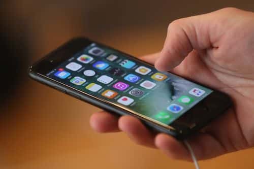 A visitor tries out an Apple iPhone 7 on the first day of sales of the new phone at the Berlin Apple store on September 16, 2016 in Berlin, Germany. The new phone comes in two sizes, one with a 4.7 inch display, the other with a 5.5 inch display.