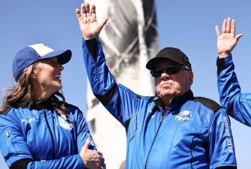 Blue Origins vice president of mission and flight operations Audrey Powers (L) looks on as Star Trek actor William Shatner waves during a media availability on the landing pad of Blue Origin’s New Shepard after they flew into space on October 13, 2021 near Van Horn, Texas. Shatner became the oldest person to fly into space on the ten minute flight. They flew aboard mission NS-18, the second human spaceflight for the company which is owned by Amazon founder Jeff Bezos. (Photo by Mario Tama/Getty Images)