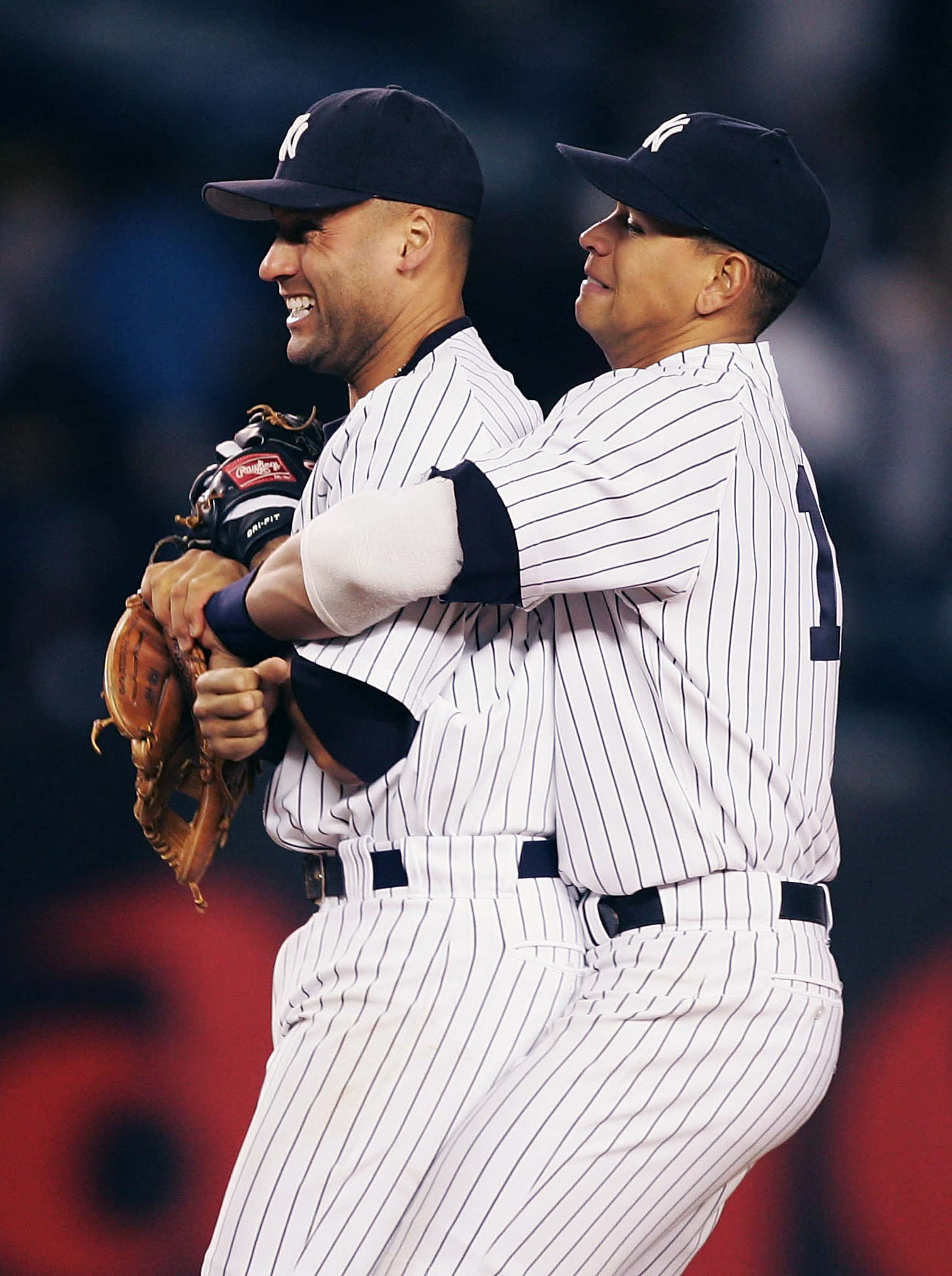 Alex Rodriguez #13 of the New York Yankees hugs Derek Jeter #2 after defeating the Seattle Mariners on May 9, 2005 at Yankee Stadium in the Bronx borough of New York City. The Yankees beat the Mariners 4-3.