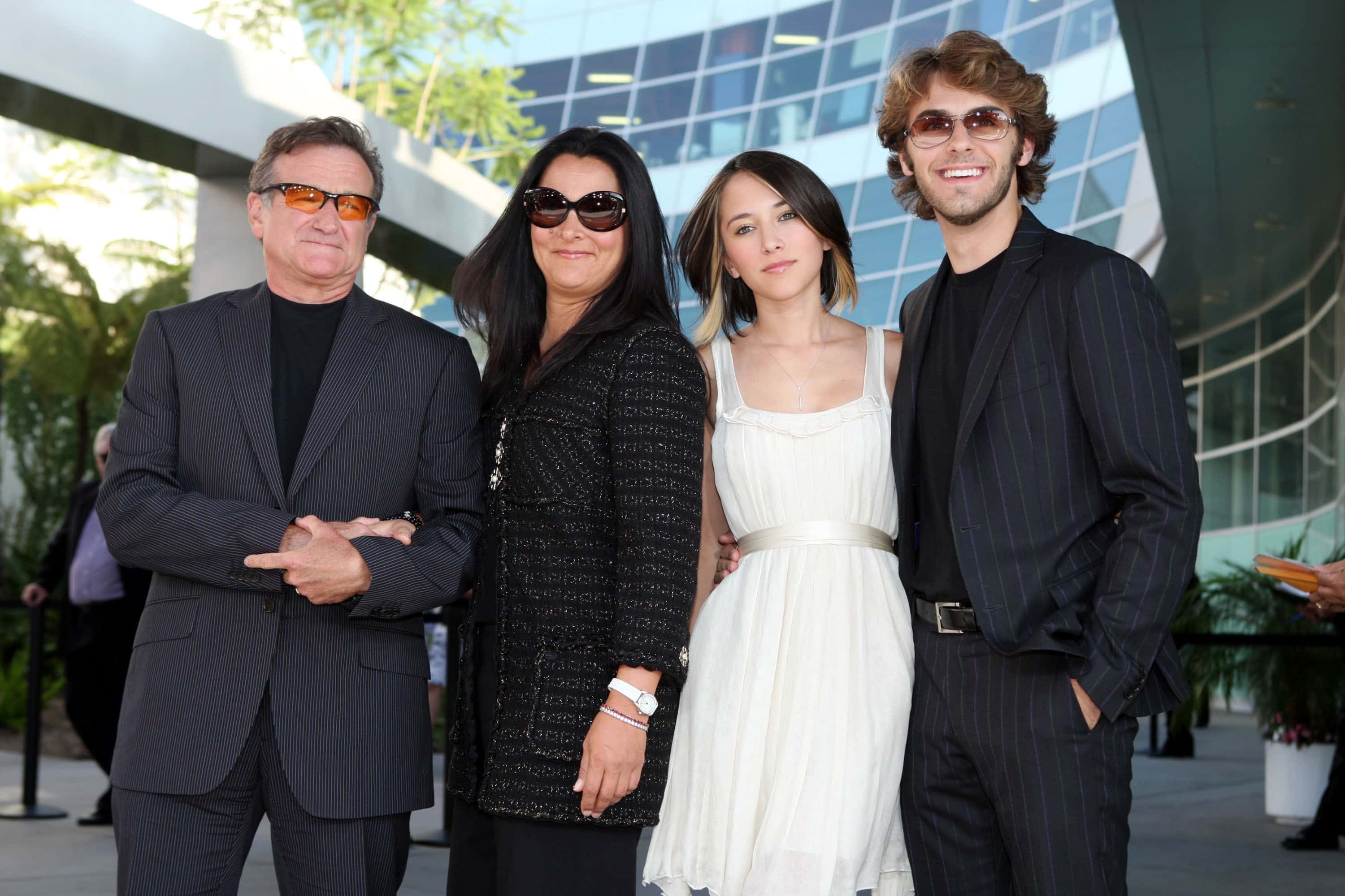 Actor Robin Williams (L) , his wife Marsha Garces, their daughter Zelda and her boyfriend pose at the premiere of Warner Bros. Pictures' 