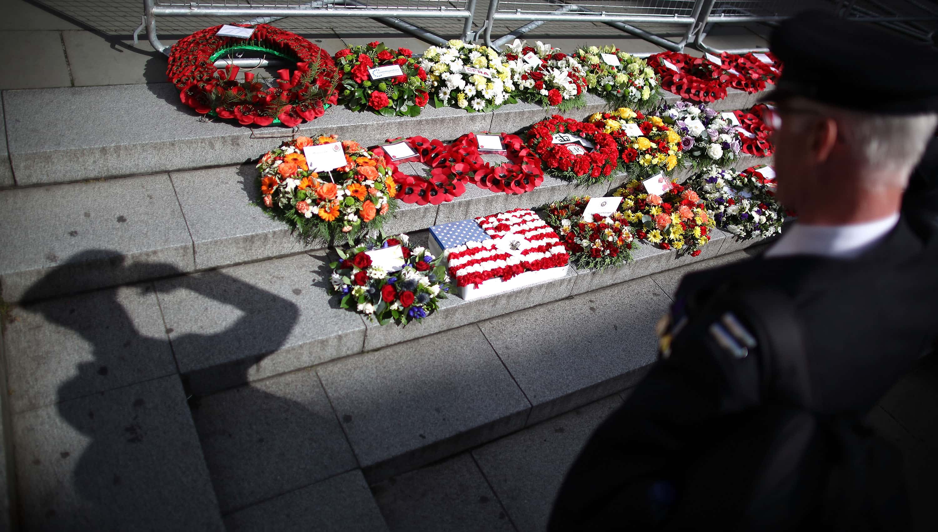 A fireman stands to attention as he looks at wreaths laid during a combined service of remembrance near St Paul's Cathedral in memory of fire fighters who have lost their lives in the United Kingdom and the 9/11 terrorist attacks in the U.S., September 11, 2011 in London, England. Ceremonies held around the world have joined Washington and New York as they commemorated the tenth anniversary of the 9/11 terrorist attacks where nearly 3000 people died when four hijacked airliners were used in coordinated attacks against the United States. (Photo by Peter Macdiarmid/Getty Images)